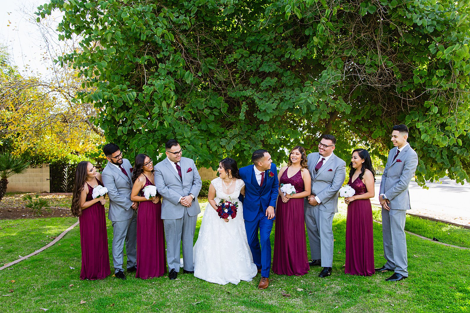 Bridal party laughing together at Valley Garden Center wedding by Phoenix wedding photographer PMA Photography.