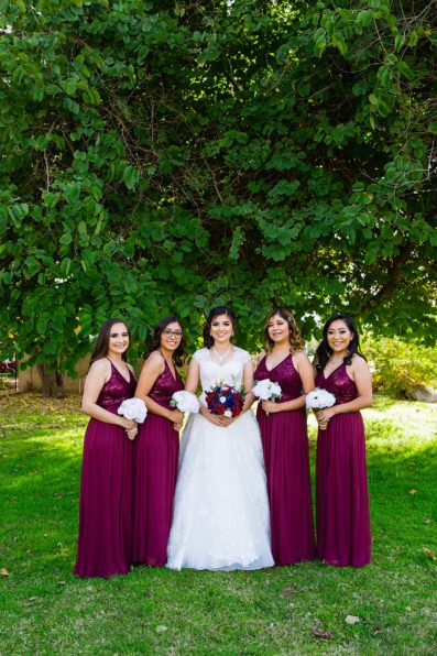 Bride and bridesmaids together at a Valley Garden Center wedding by Arizona wedding photographer PMA Photography.