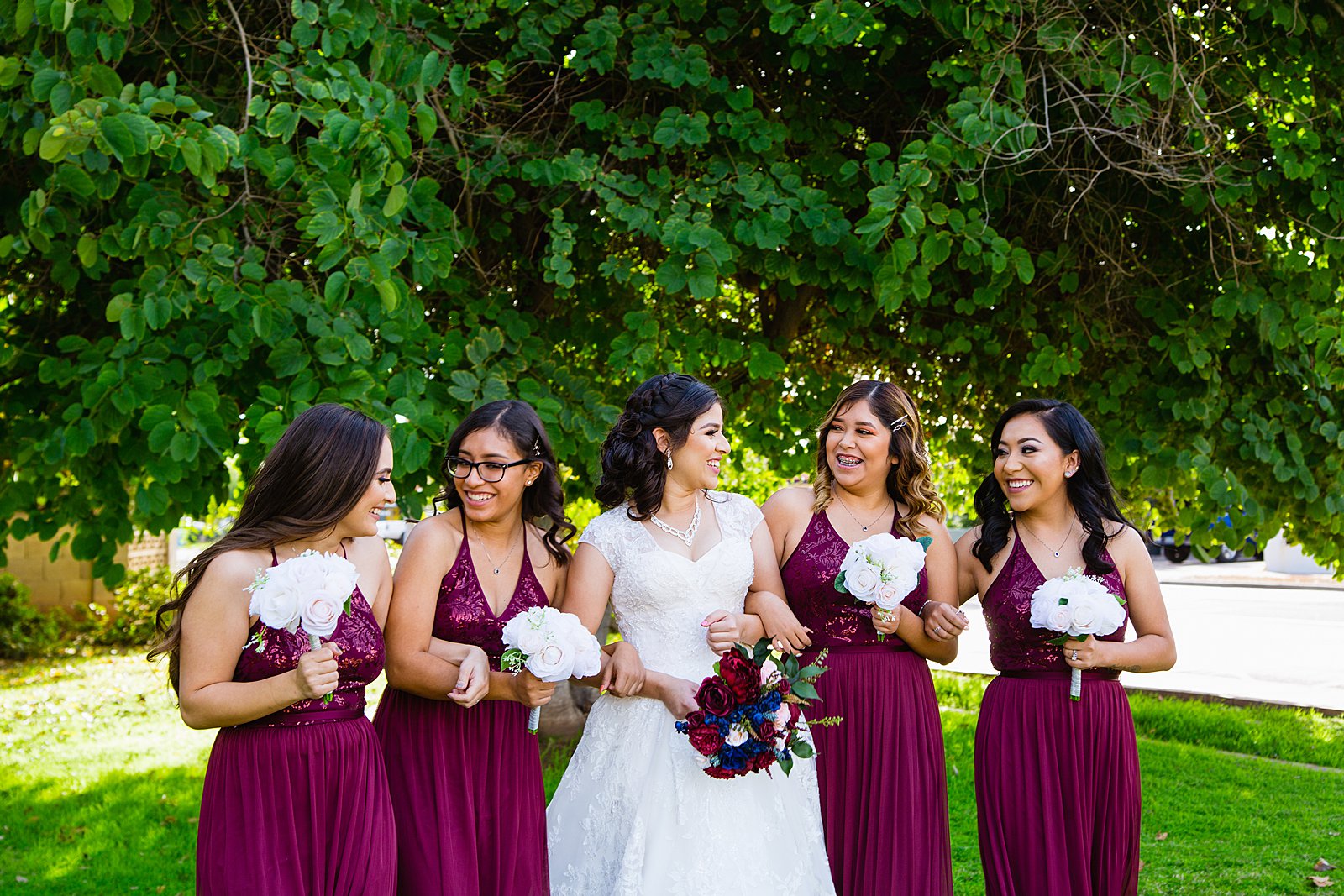 Bride and bridesmaids laughing together at Valley Garden Center wedding by Phoenix wedding photographer PMA Photography.