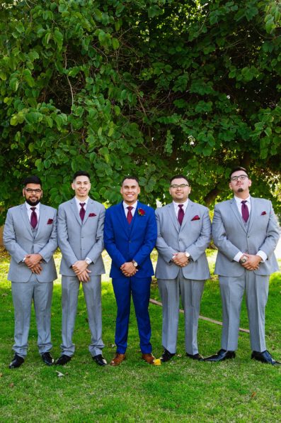 Groom and groomsmen together at a Valley Garden Center wedding by Arizona wedding photographer PMA Photography.
