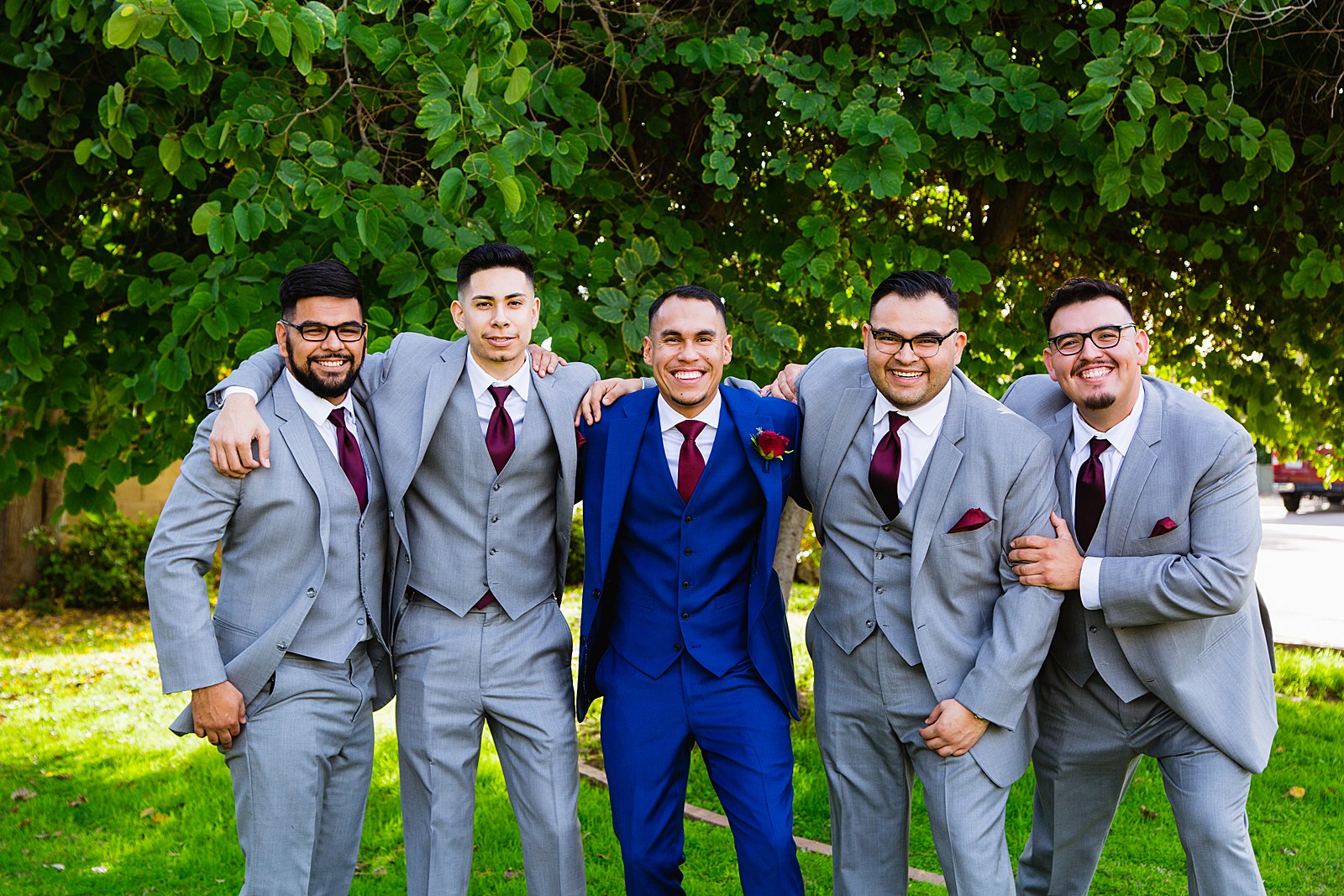Groom and groomsmen laughing together at Valley Garden Center wedding by Phoenix wedding photographer PMA Photography.