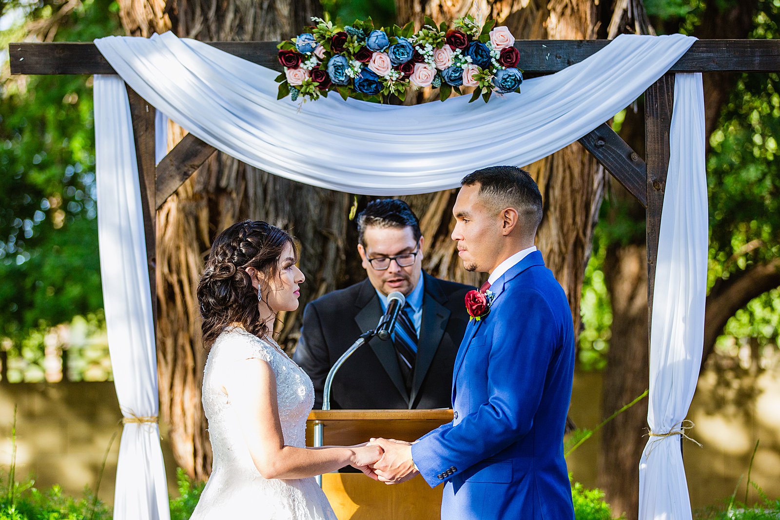 Bride and Groom togethering during Valley Garden Center wedding ceremony by Phoenix wedding photographer PMA Photography.