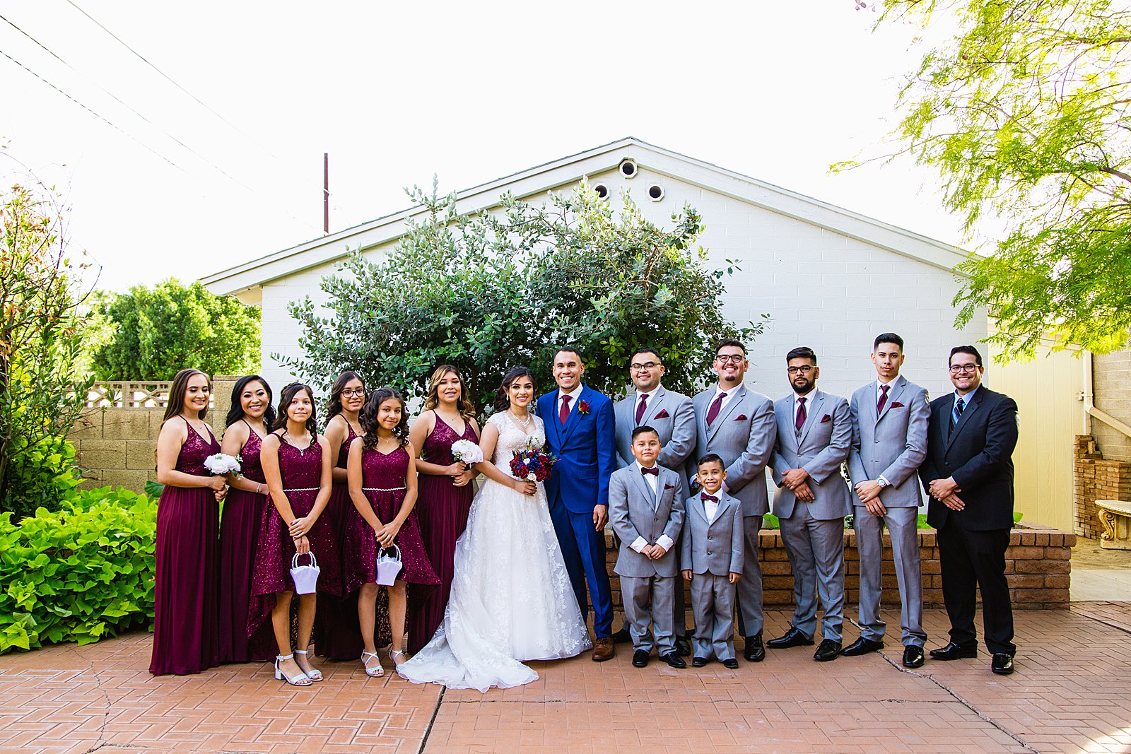 Bridal party together at a Valley Garden Center wedding by Arizona wedding photographer PMA Photography.