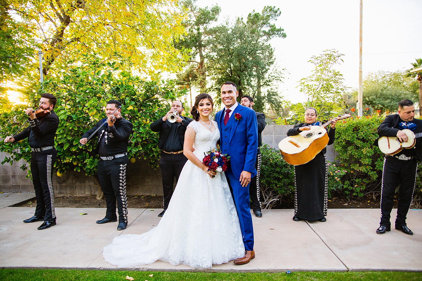 Bride and groom with a mariachi band during cocktail hour at Valley Garden Center wedding by PMA Photography.