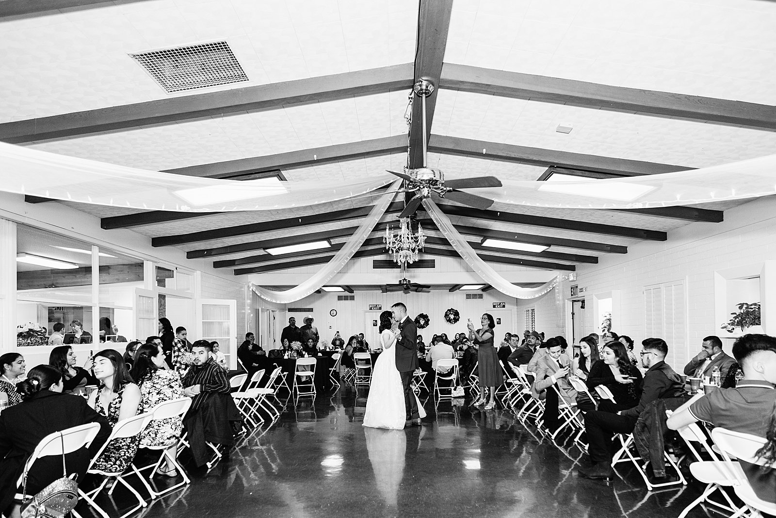 Bride and Groom sharing first dance at their Valley Garden Center wedding reception by Arizona wedding photographer PMA Photography.