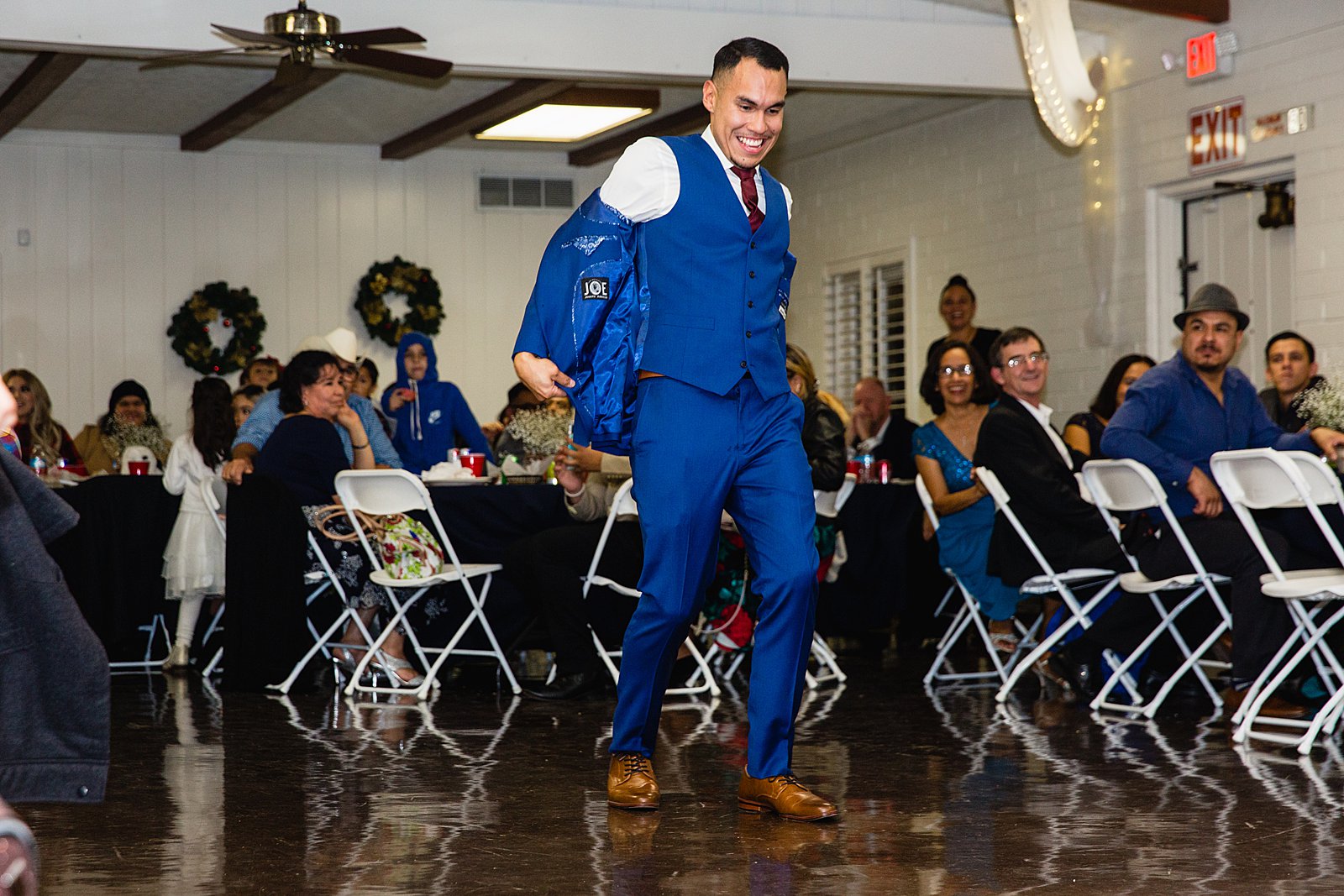 Garter toss at Valley Garden Center wedding reception by Phoenix wedding photographer PMA Photography.
