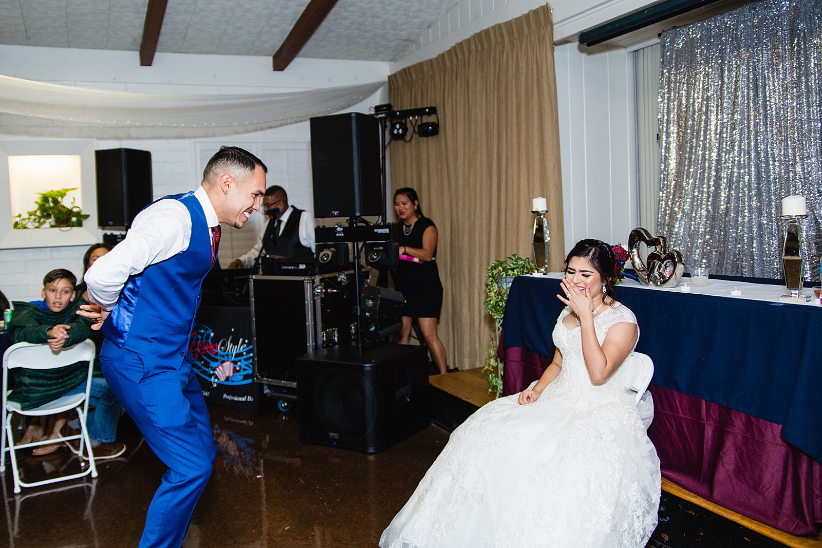 Garter toss at Valley Garden Center wedding reception by Phoenix wedding photographer PMA Photography.