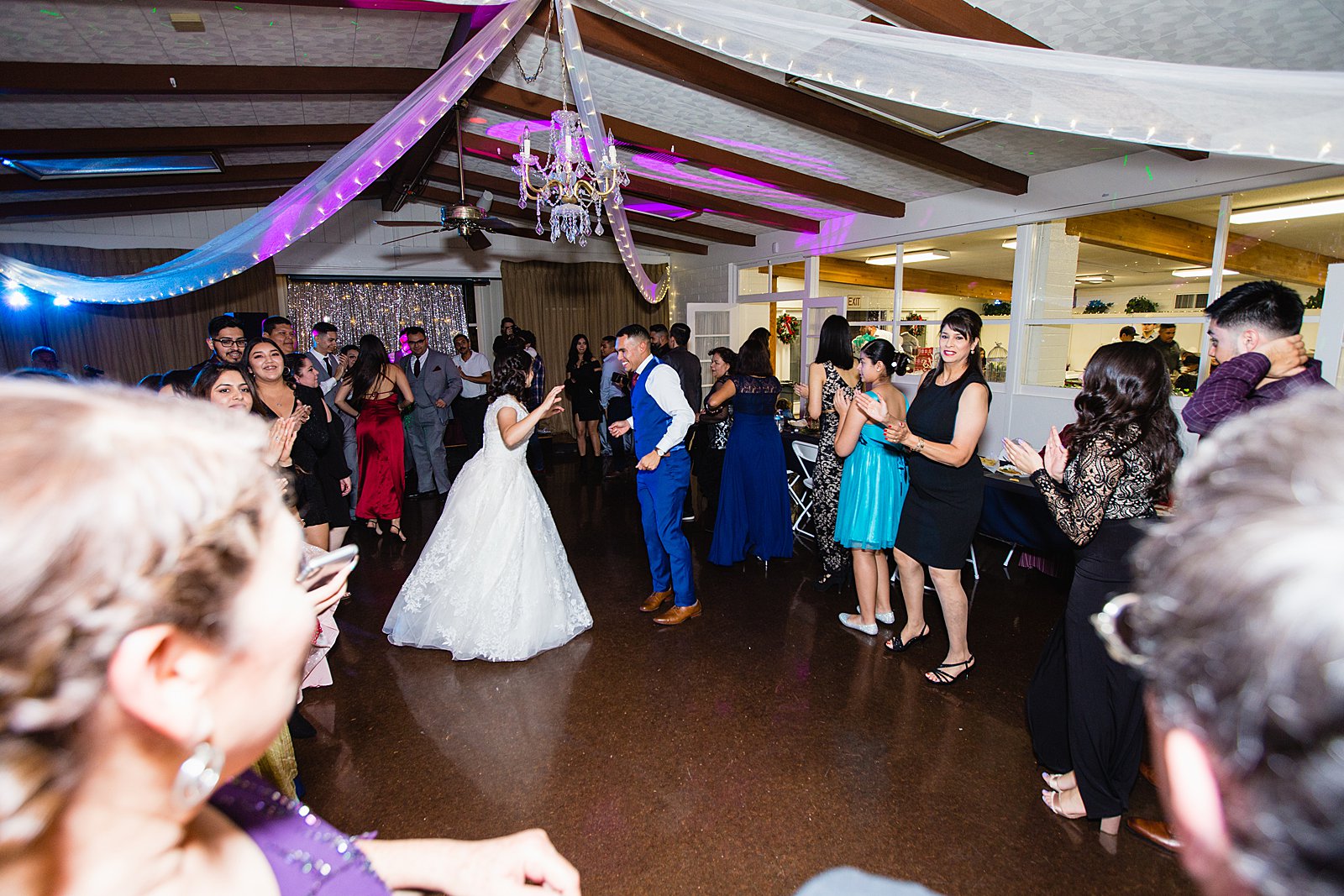 Bride and groom dancing with guests at Valley Garden Center wedding reception by Phoenix wedding photographer PMA Photography
