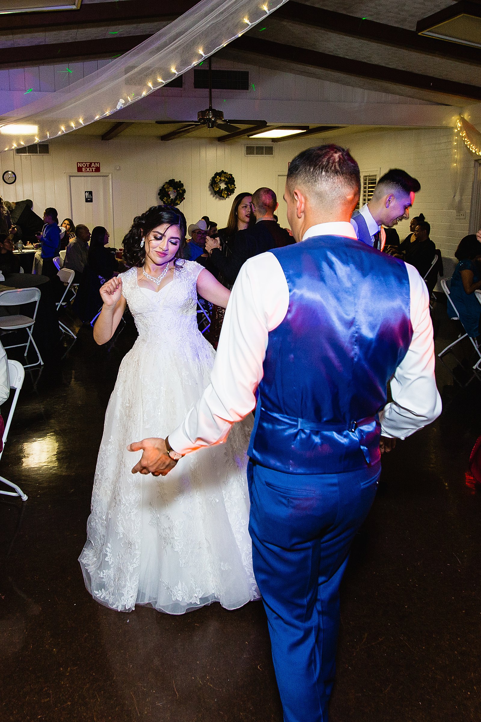 Bride and groom dancing with guests at Valley Garden Center wedding reception by Phoenix wedding photographer PMA Photography