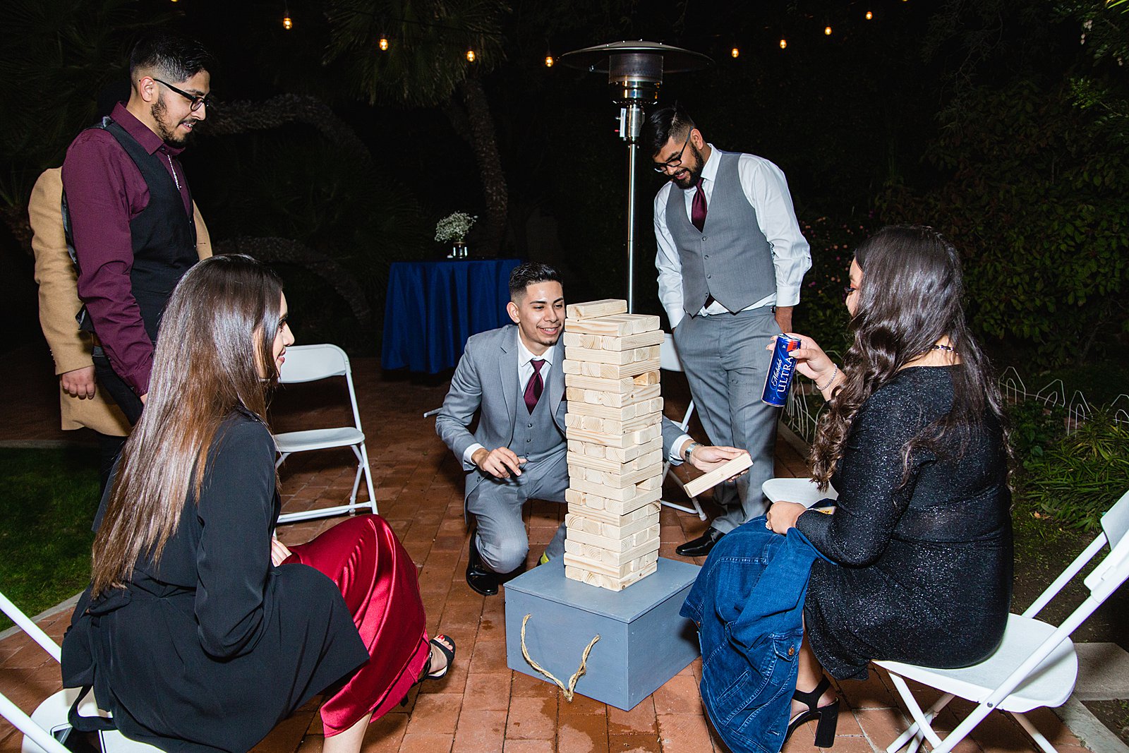 Guests playing jenga at Valley Garden Center wedding reception by PMA Photography.