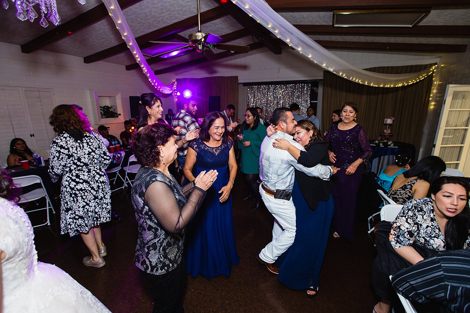 Guests dancing together at Valley Garden Center wedding reception by Phoenix wedding photographer PMA Photography