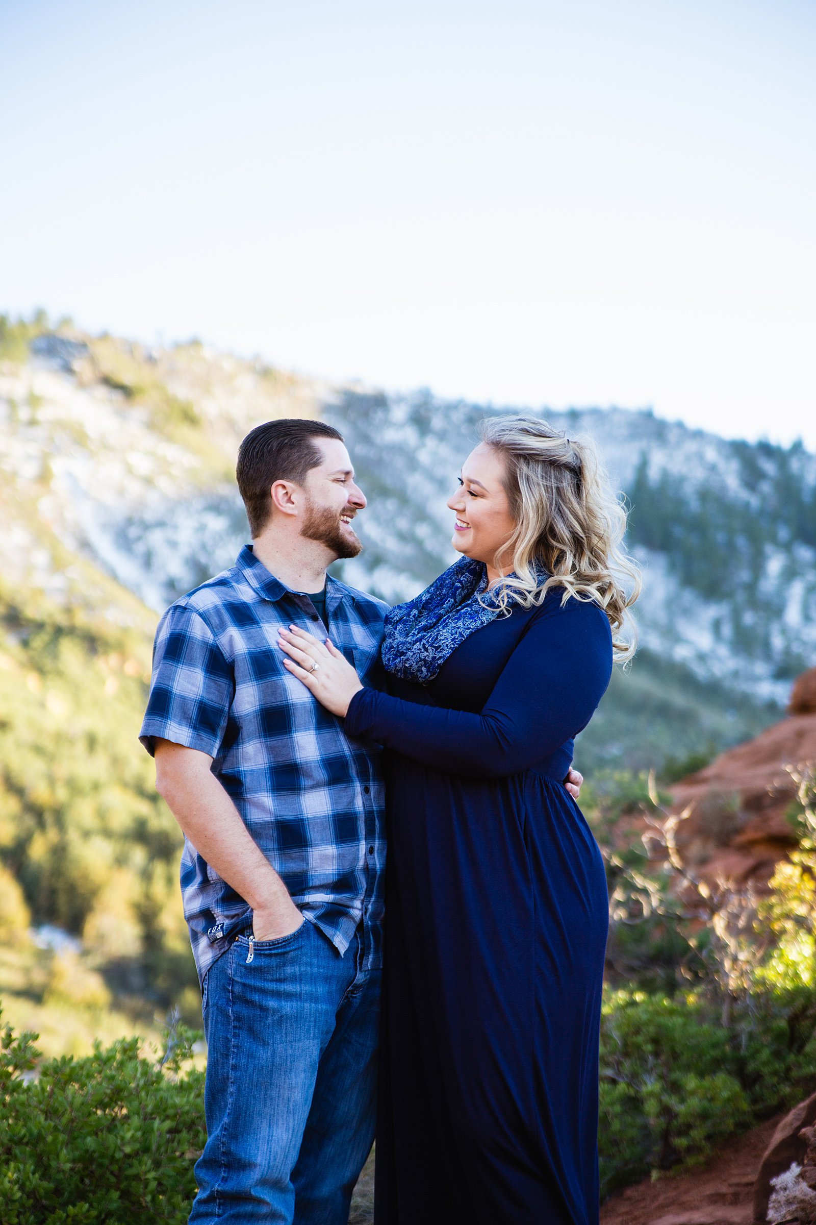 Couple laugh together during their Sedona engagement session by Arizona engagement photographer PMA Photography.