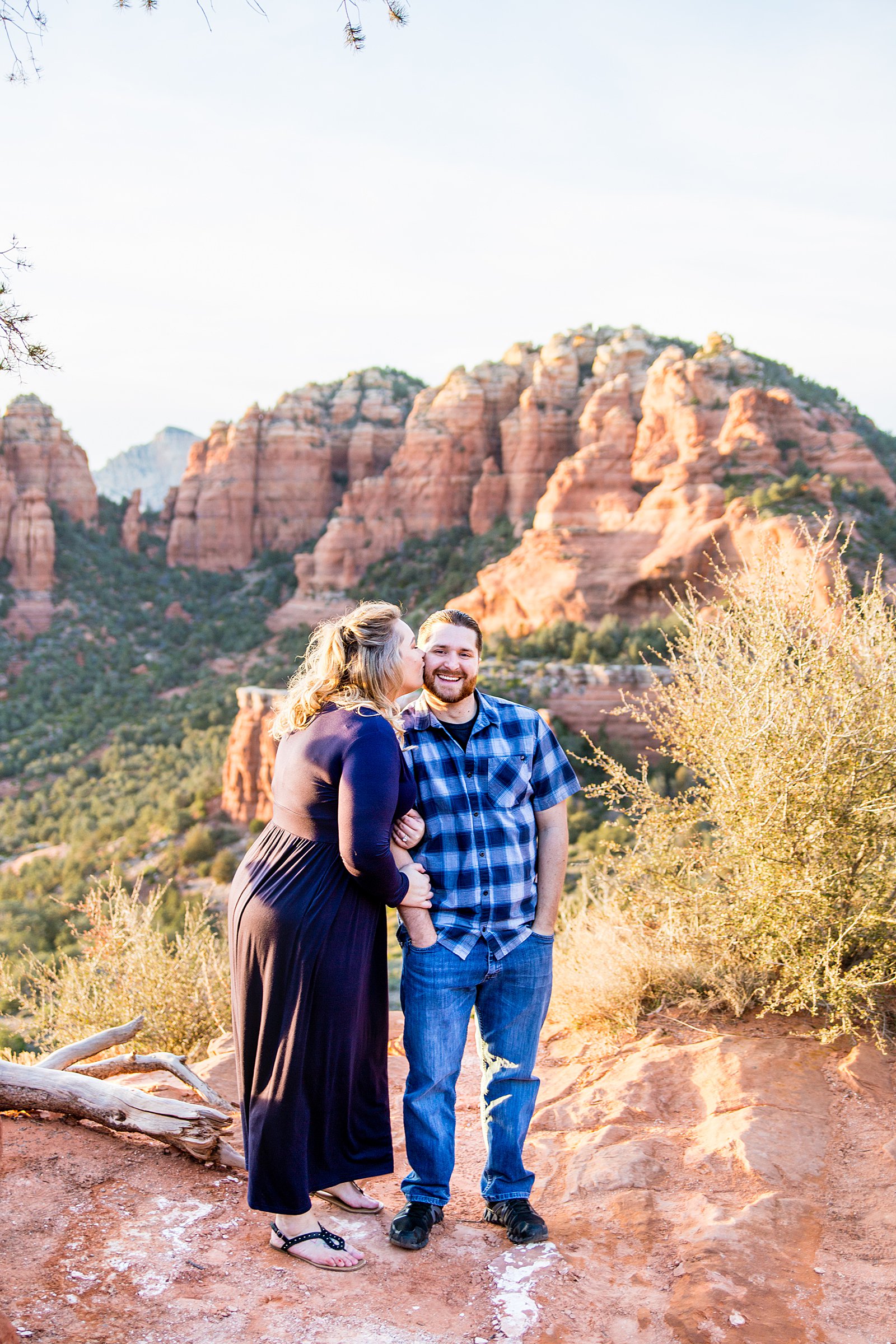 Adventurous couple pose during their Sedona engagement session by Arizona wedding photographer PMA Photography.