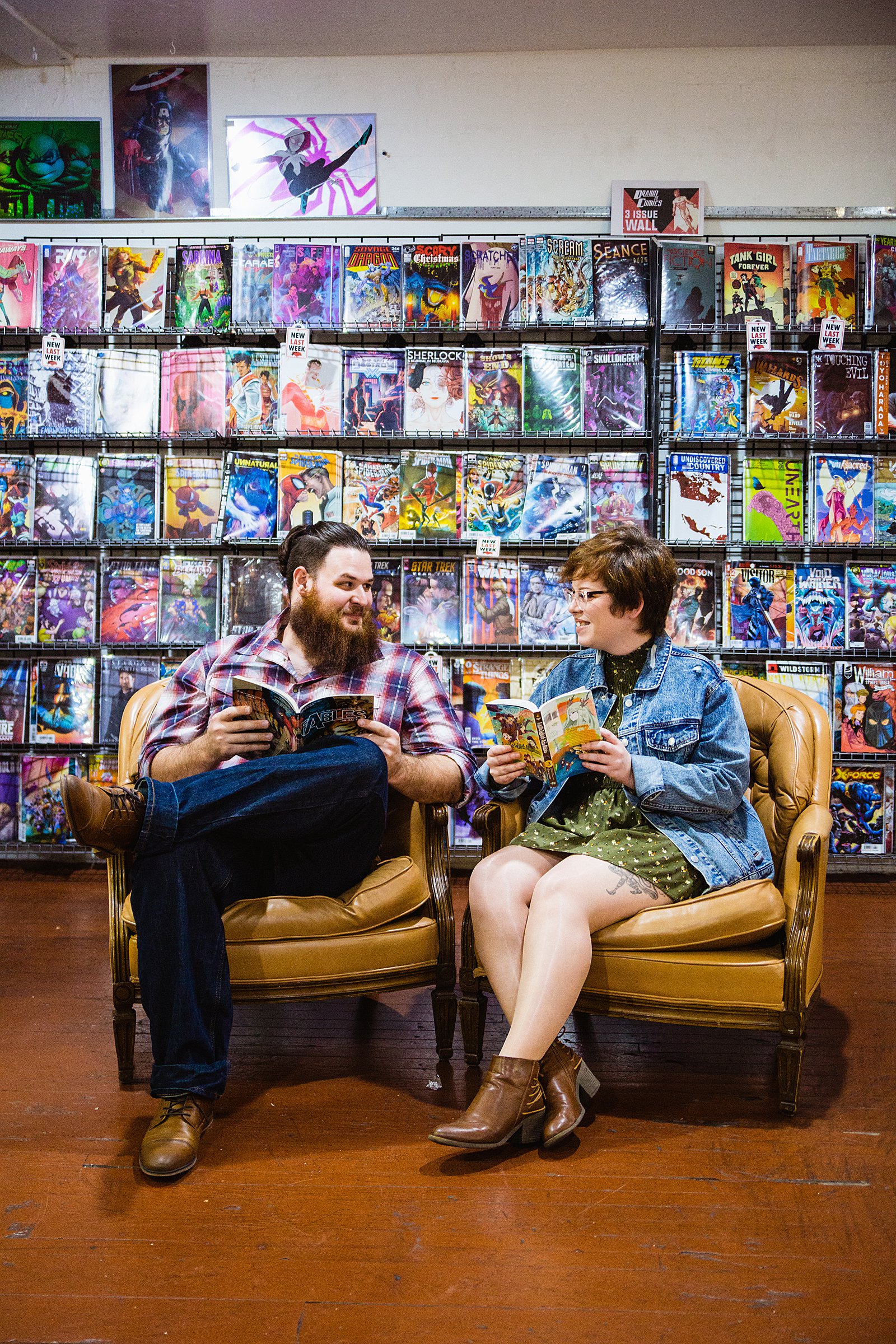 Couple look at each other during their Comic Book Store engagement session by Glendale wedding photographer PMA Photography.