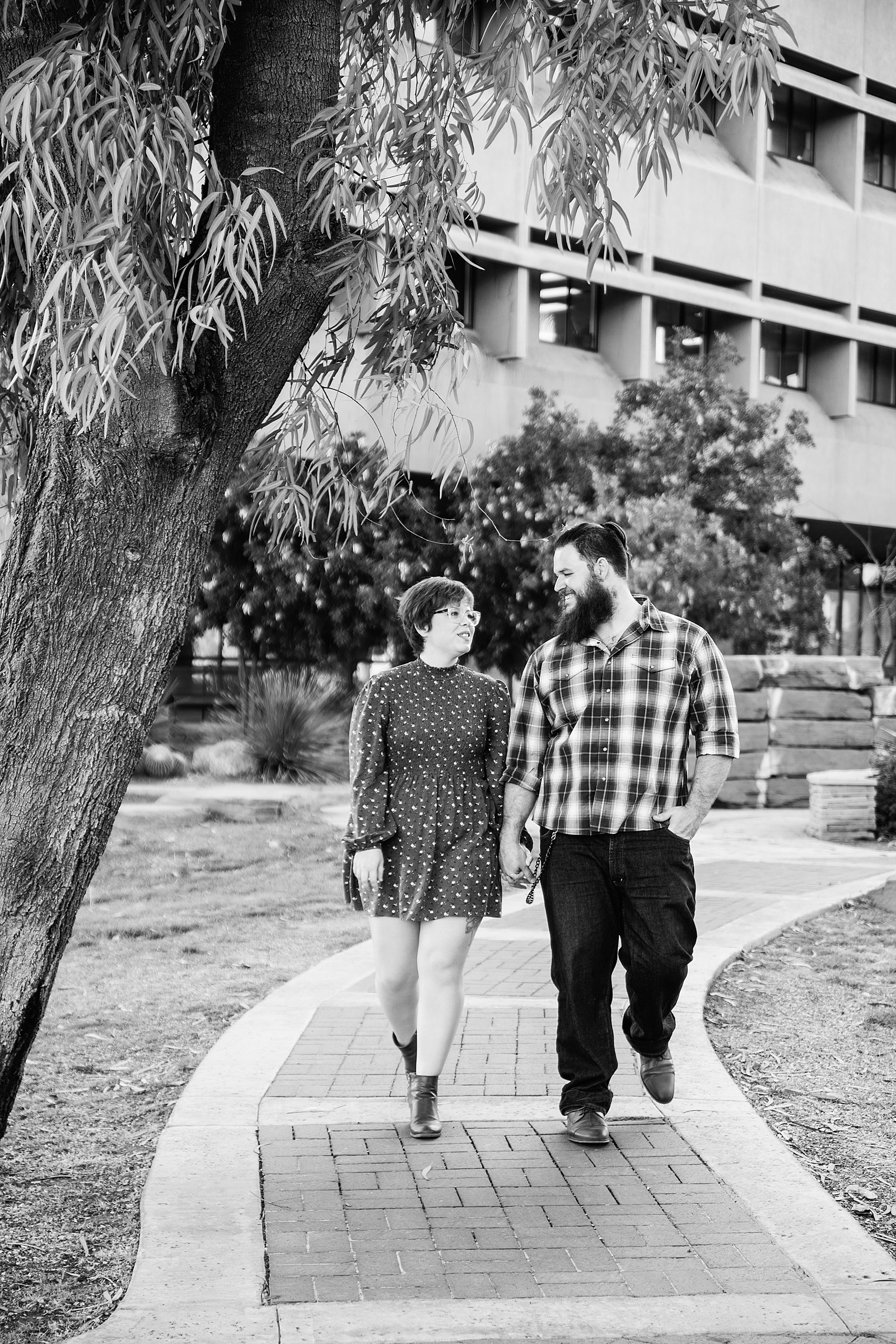 Couple walking together during their Downtown Glendale engagement session by Glendale engagement photographer PMA Photography.