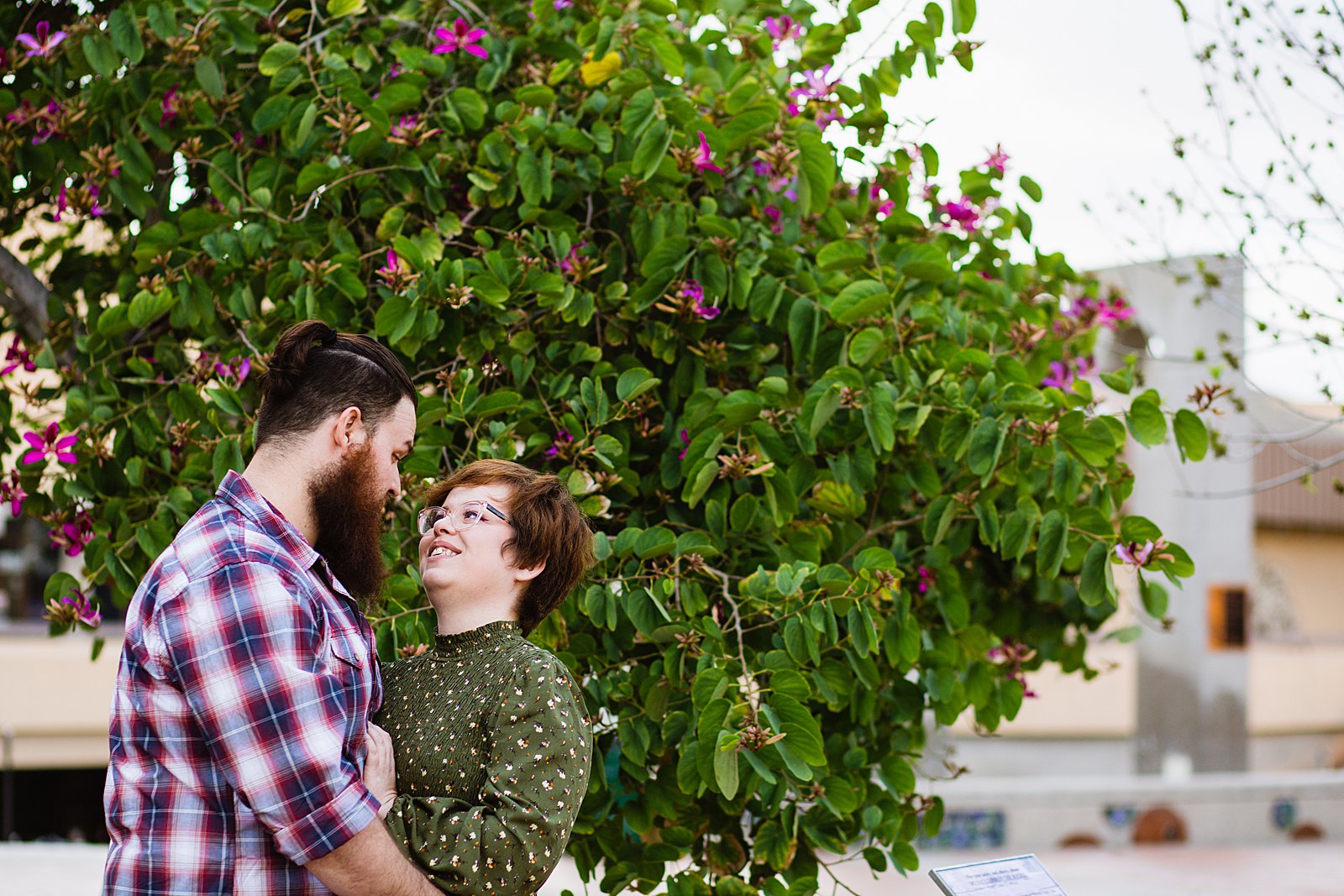 Couple look at each other during their Downtown Glendale engagement session by Glendale wedding photographer PMA Photography.