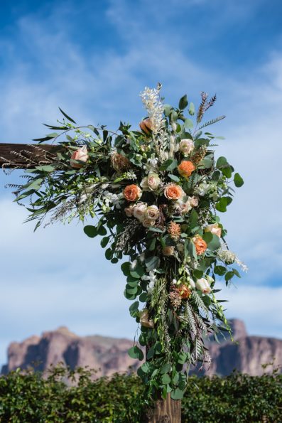 Wedding ceremony rustic and floral wedding arch at The Paseo by Phoenix wedding photographer PMA Photography.