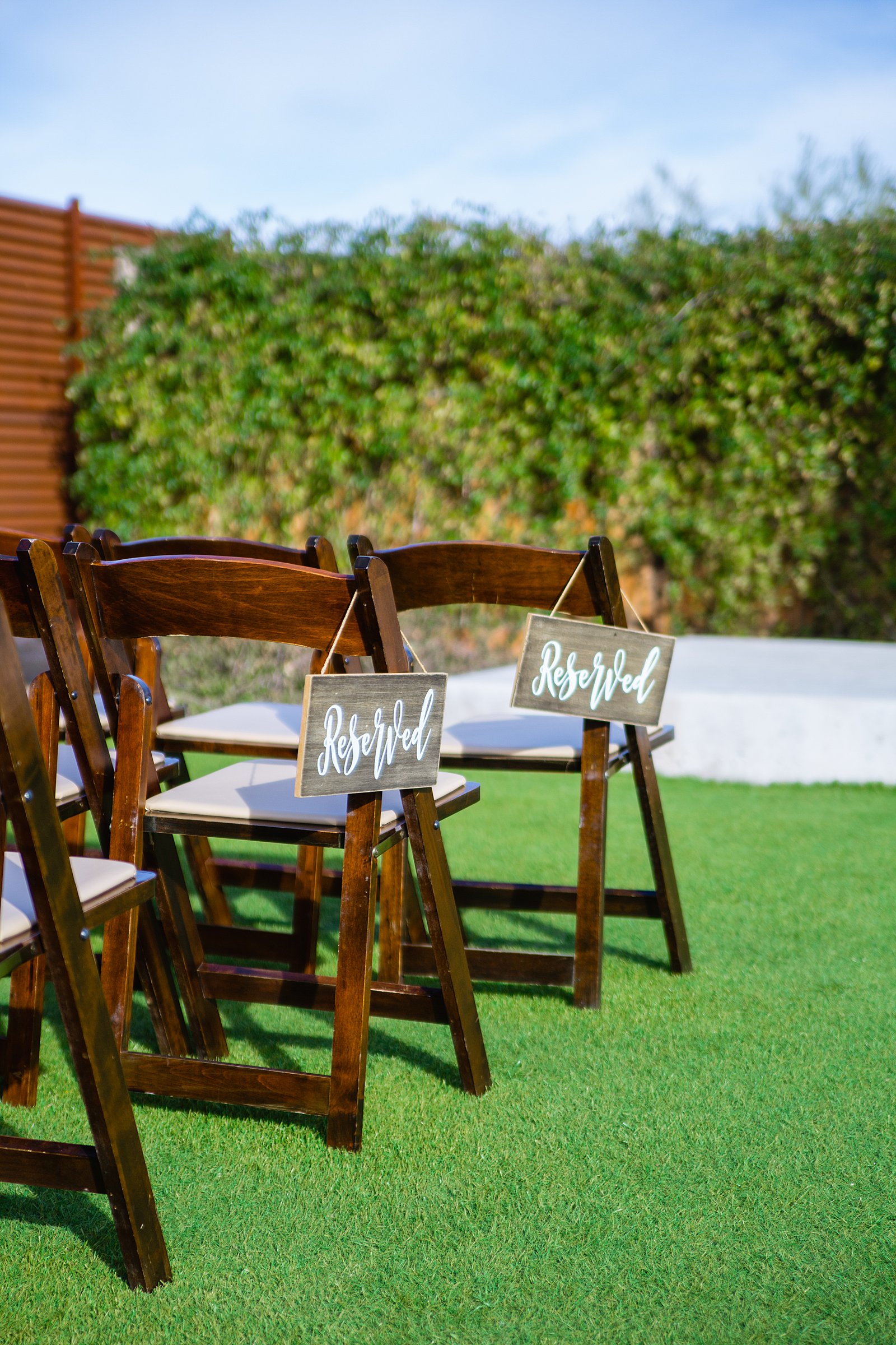 Modern, rustic reserved seating signs at The Paseo wedding ceremony by PMA Photography.