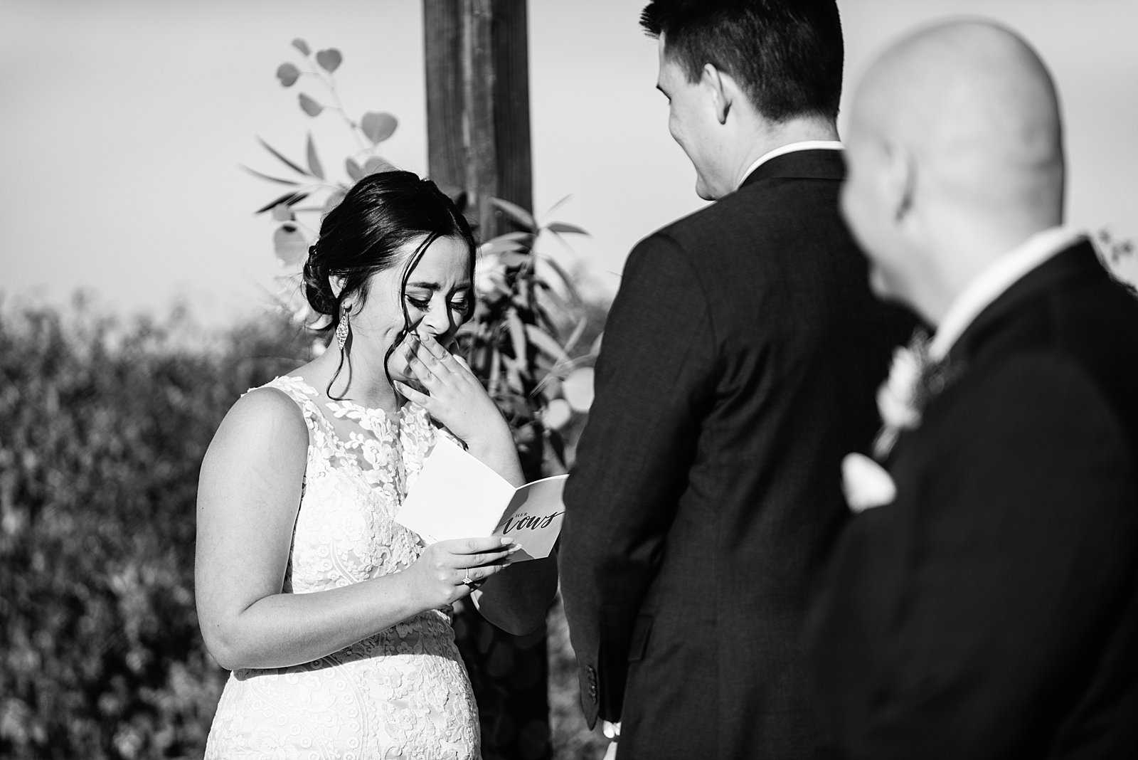 Bride crying while giving her vows during their wedding ceremony at The Paseo by Apache Junction wedding photographer PMA Photography.