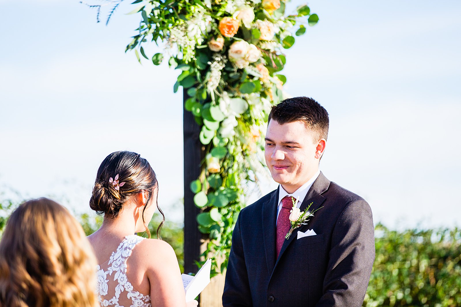 Groom looking at his bride during their wedding ceremony at The Paseo by Apache Junction wedding photographer PMA Photography.
