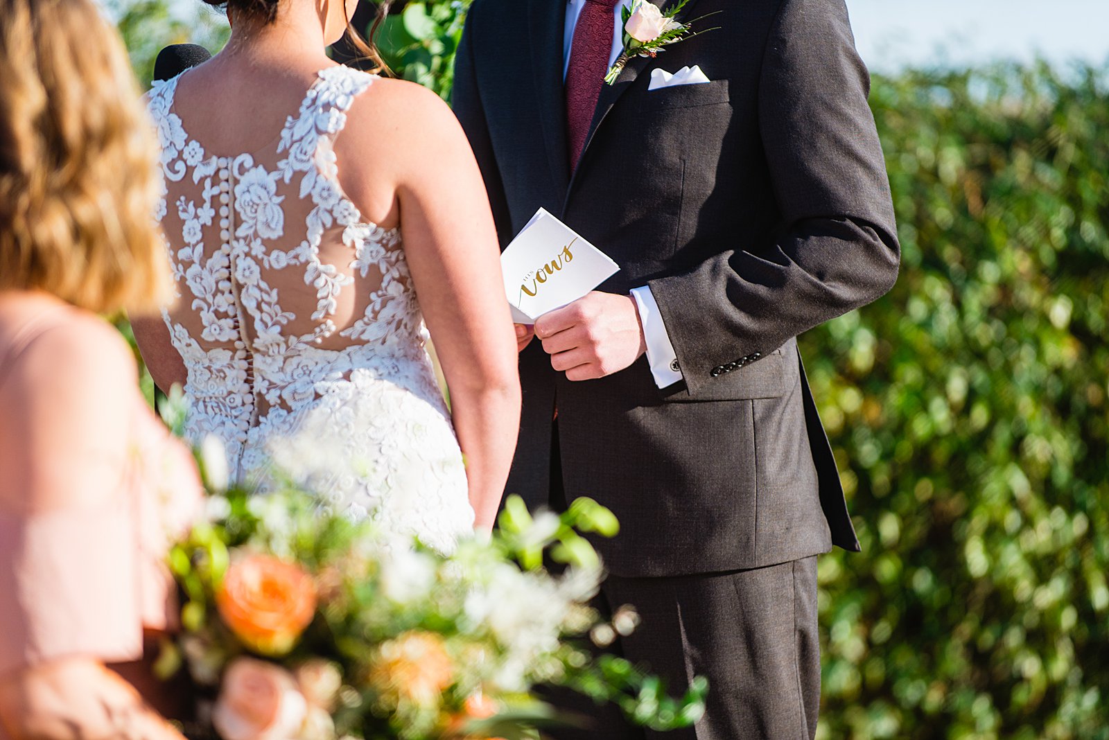 Groom holding his wedding vows notebook during their wedding ceremony by PMA Photography.