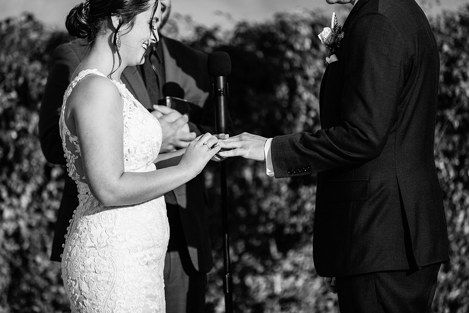 Bride and Groom exchange rings during their wedding ceremony at The Paseo by Phoenix wedding photographer PMA Photography.