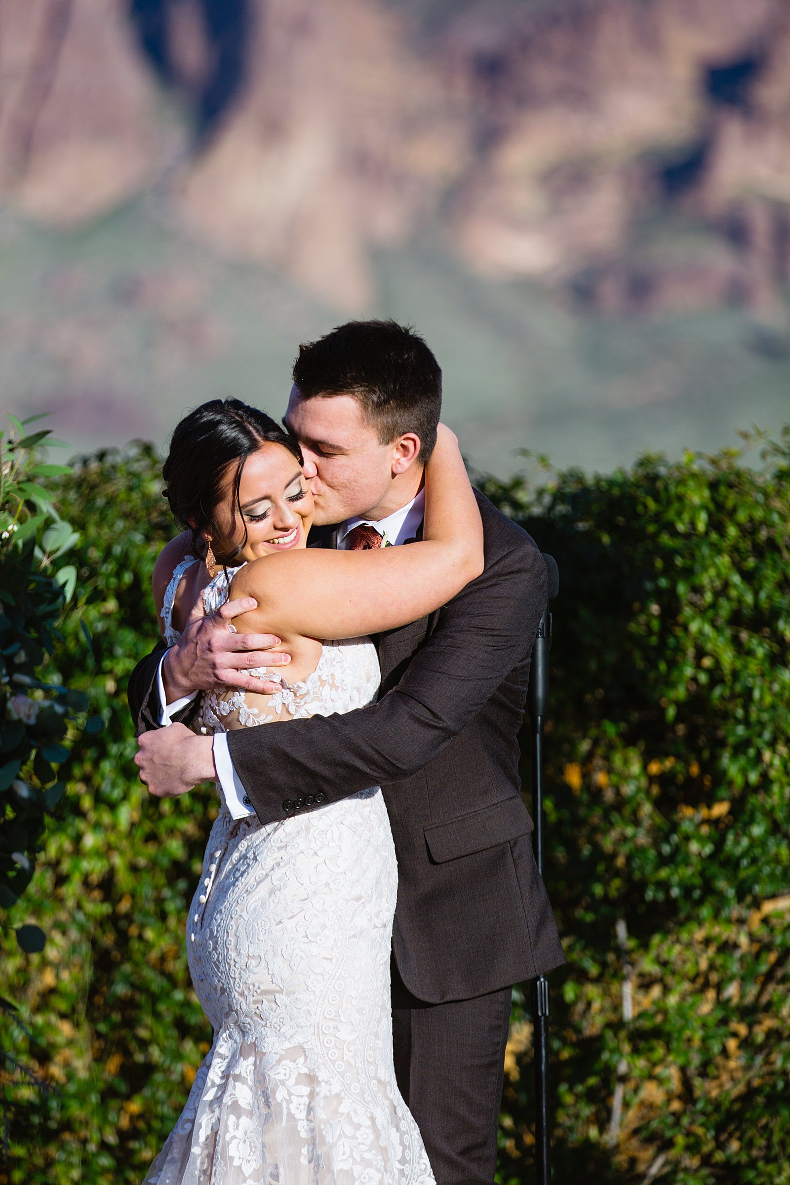 Bride and Groom share their first kiss during their wedding ceremony at The Paseo by Arizona wedding photographer PMA Photography.