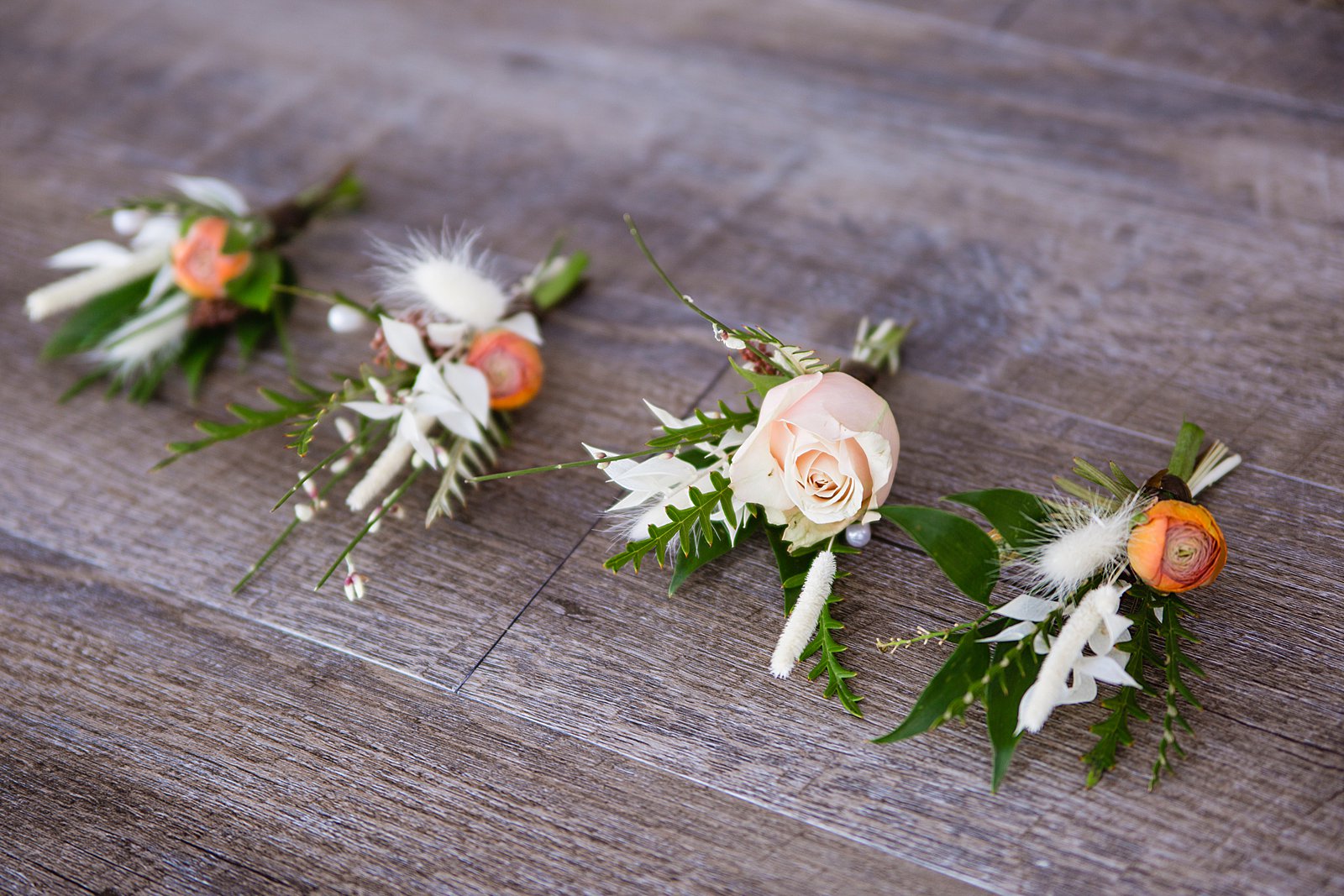 Groom and groomsmen's wild desert inspired peach and cream boutonniere by PMA Photography.