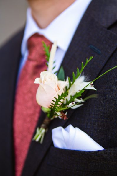 Groom's wild desert inspired rose boutonniere by PMA Photography.