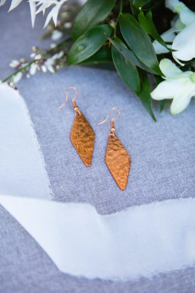 Bride's unique copper drop earrings for her desert wedding at The Paseo by PMA Photography.
