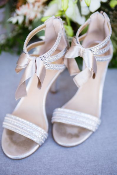 Brides's cream heals with a bow wedding day details by PMA Photography.