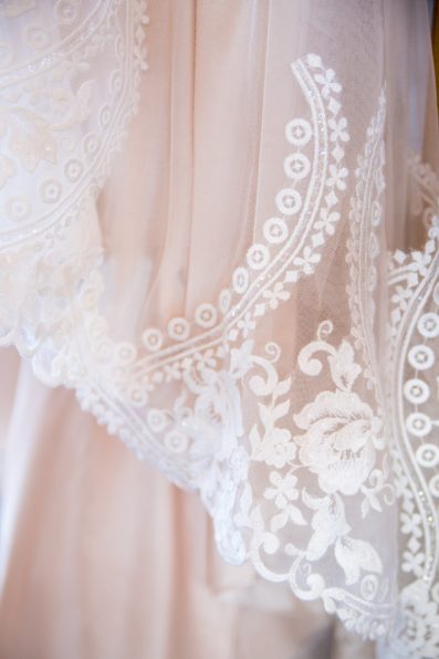 Bride's romantic peach lace wedding dress detail for her The Paseo wedding by PMA Photography.