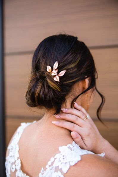 Bride's wedding day up-do with copper leaf hairpin by Arizona wedding photographer PMA Photography.