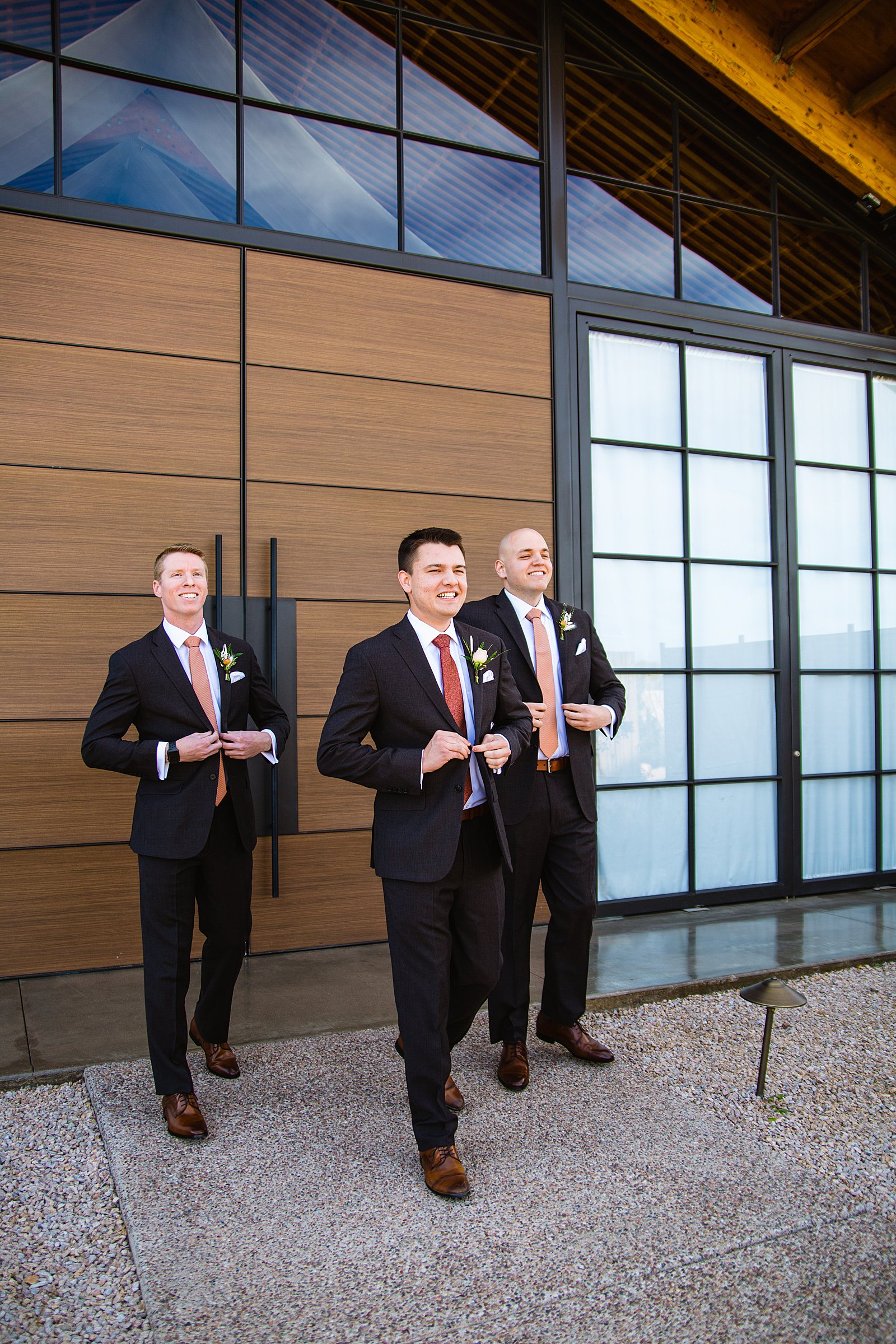Groom and groomsmen walking together at a The Paseo wedding by Arizona wedding photographer PMA Photography.