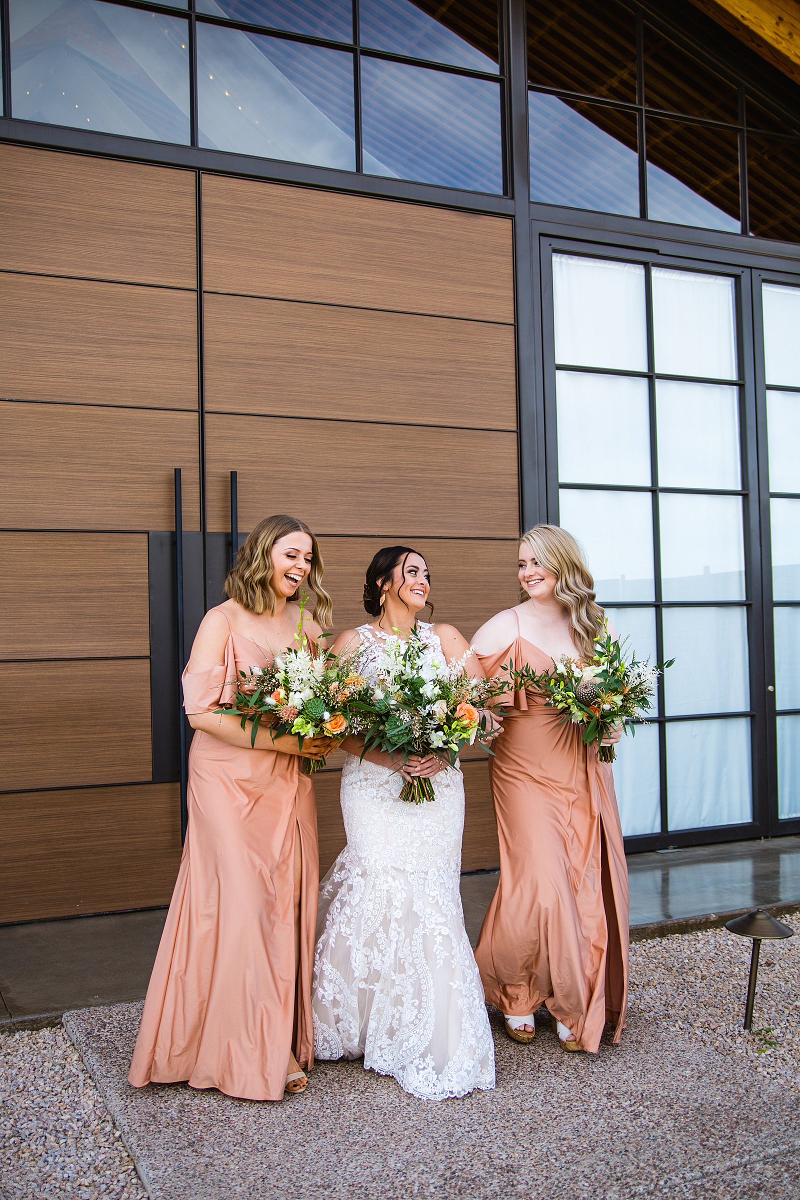 Bride and bridesmaids laughing together at The Paseo wedding by Apache Junction wedding photographer PMA Photography.