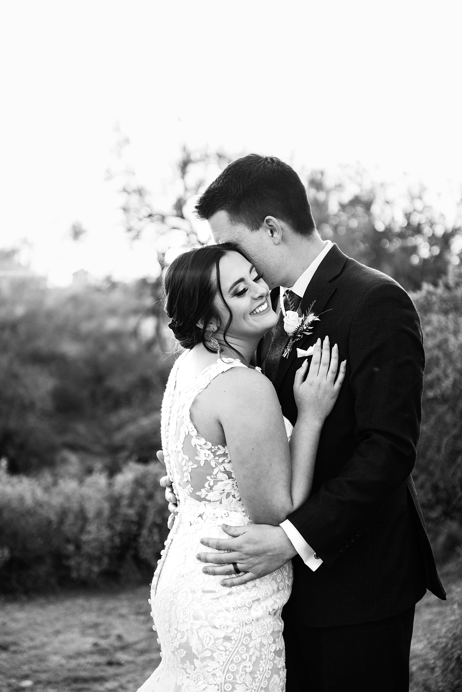 Bride and Groom laughing together during their The Paseo wedding by Arizona wedding photographer PMA Photography.