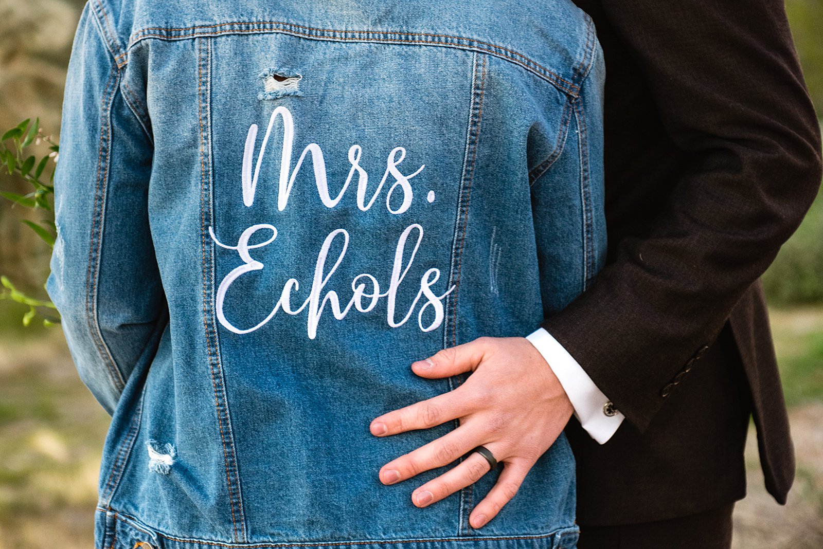 Bride's custom "Mrs." jean jacket on her wedding day by Arizona wedding photographer PMA Photography.