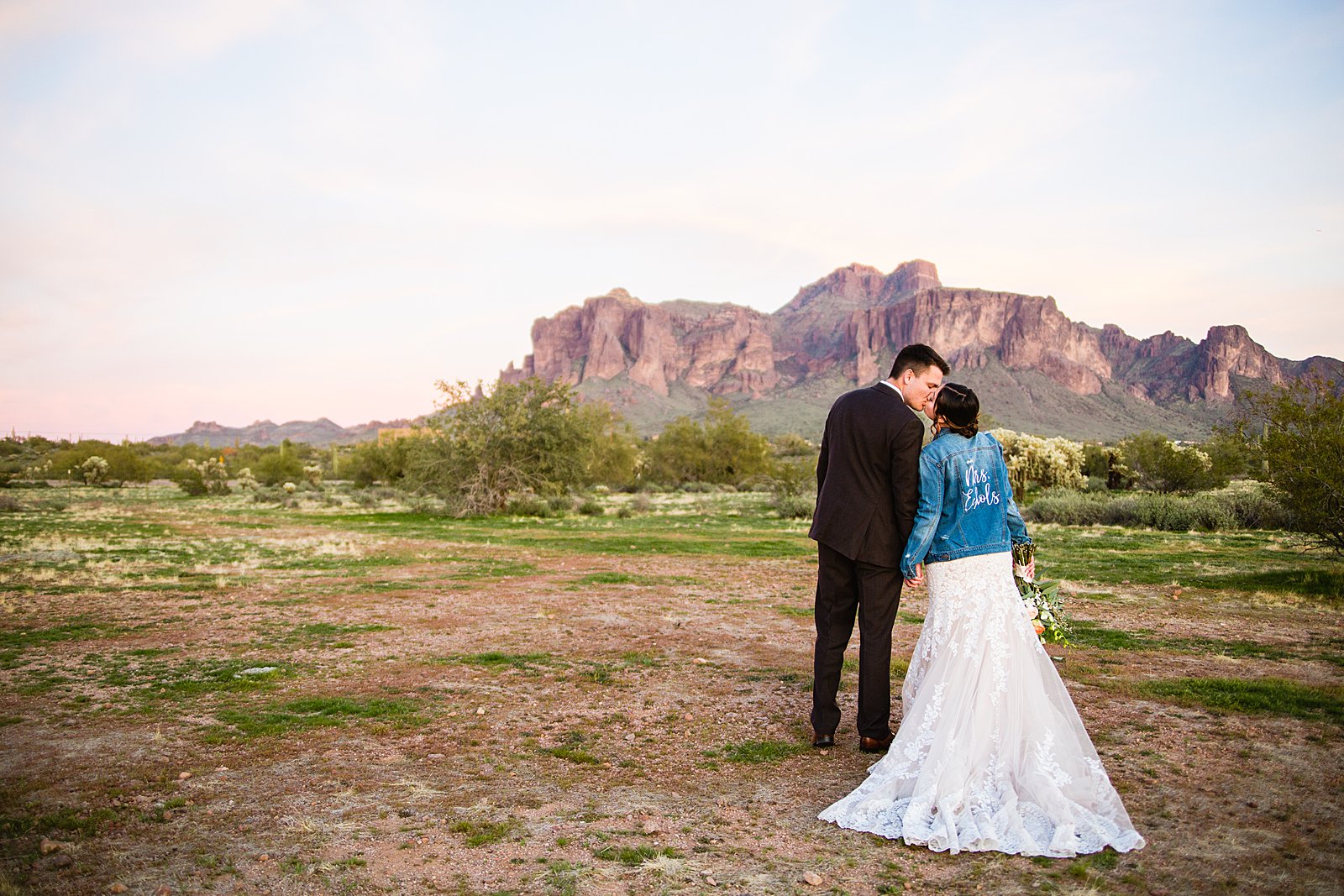 Bride and Groom share a kiss during their The Paseo wedding by Apache Junction wedding photographer PMA Photography.