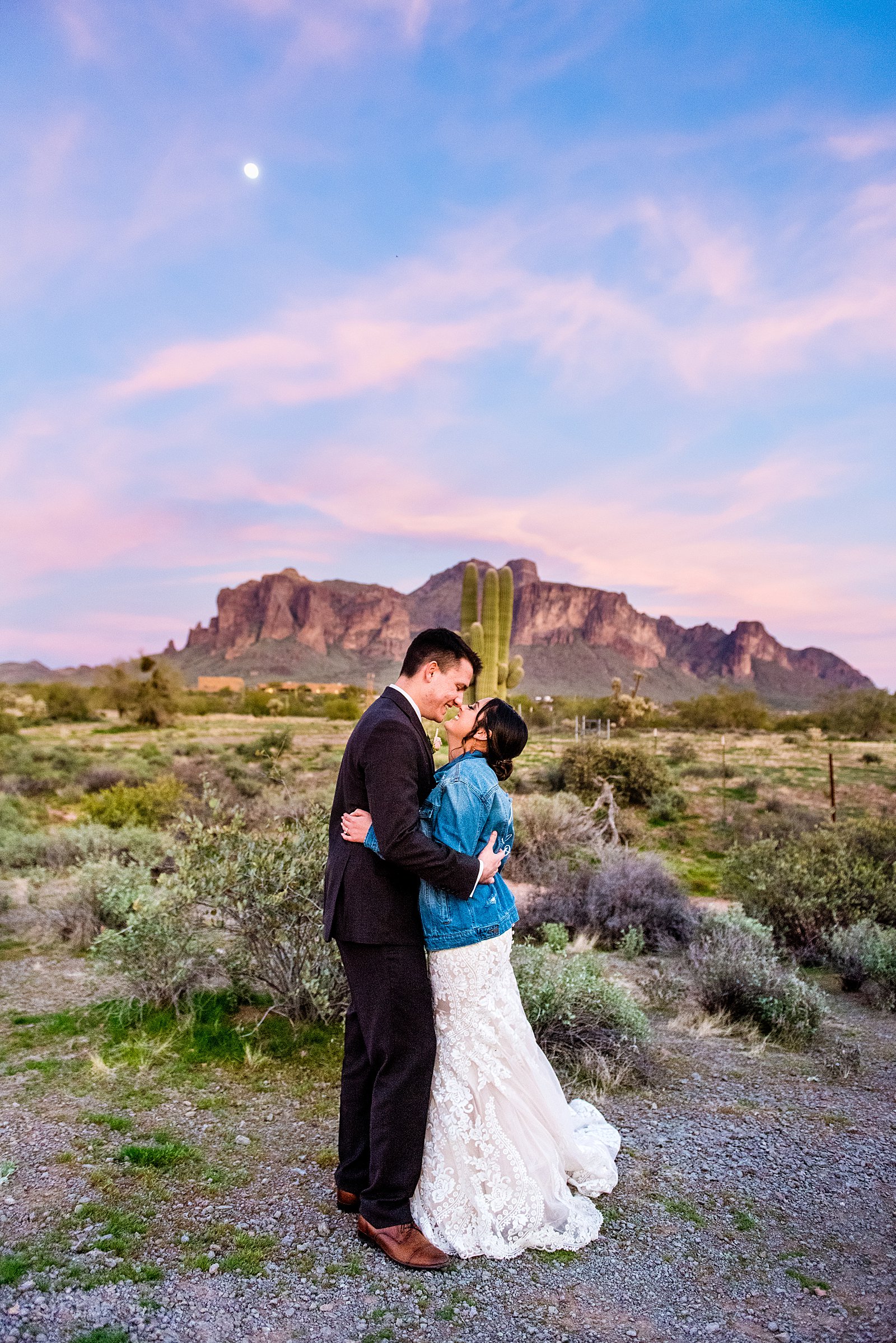 Bride and Groom share an intimate moment at sunset with epic views of the superstition mountains at their The Paseo wedding by Arizona wedding photographer PMA Photography.