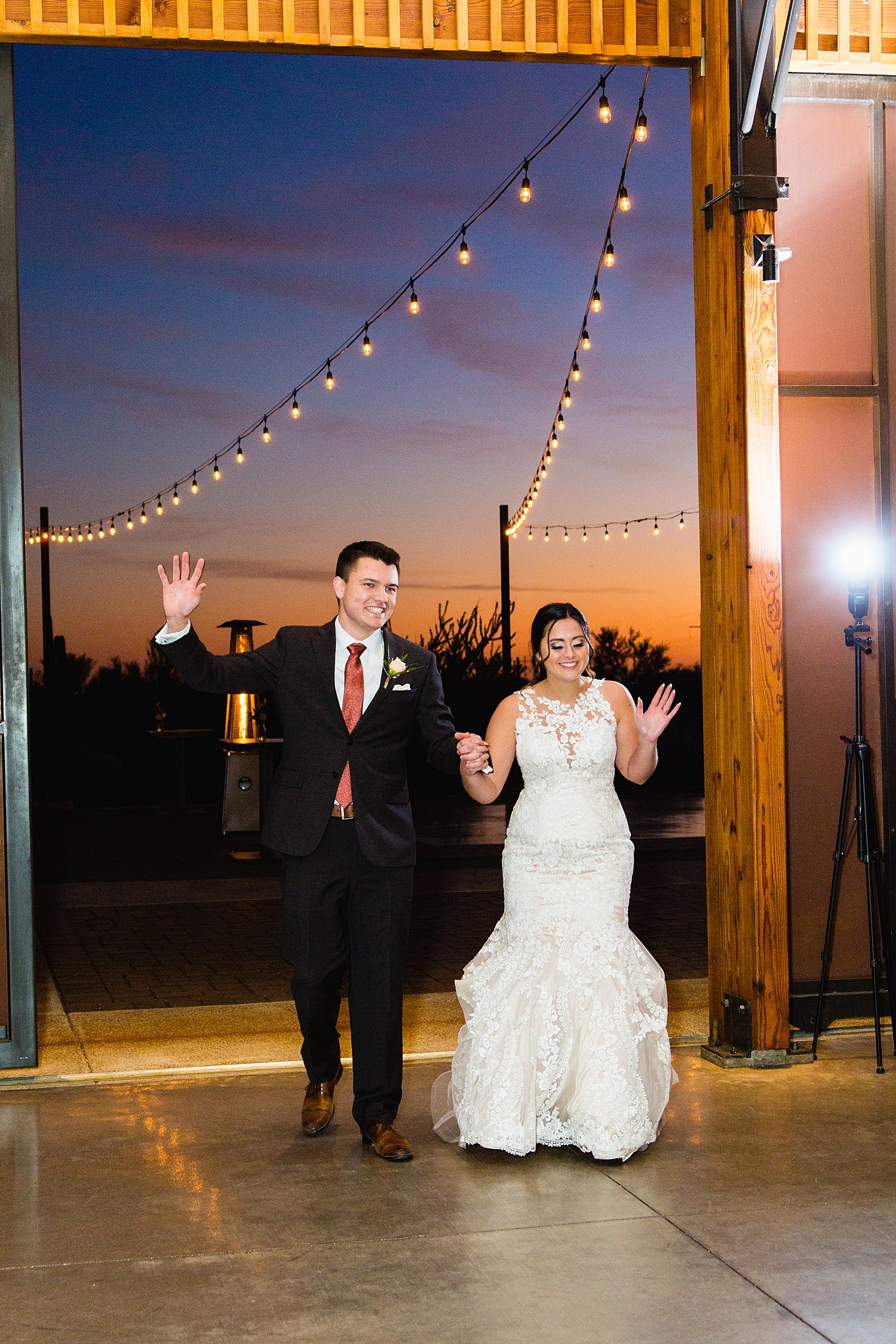 Bride and Groom's grand entrance at their The Paseo wedding reception by Arizona wedding photographer PMA Photography.