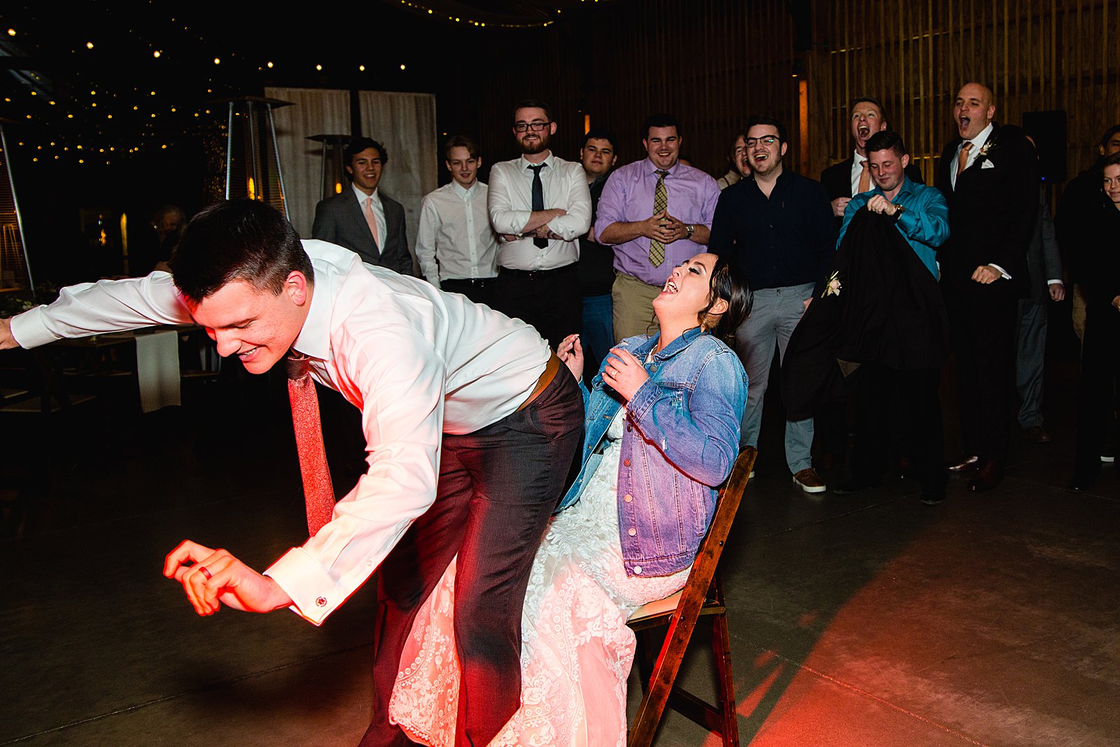 Garter toss at The Paseo wedding reception by Apache Junction wedding photographer PMA Photography.