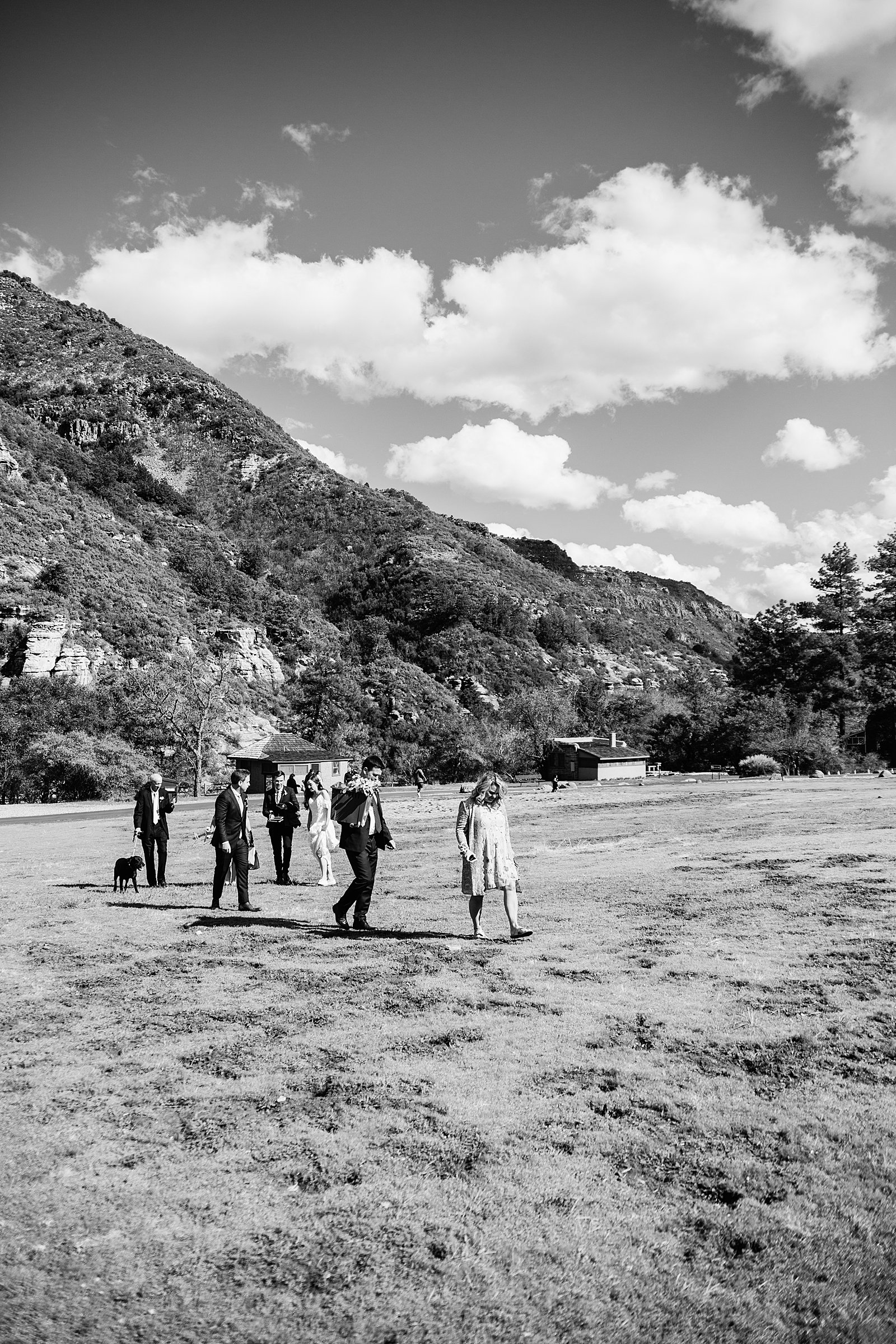 Bride and groom walking with their family to their ceremony spot for their Sedona elopement by PMA Photography.