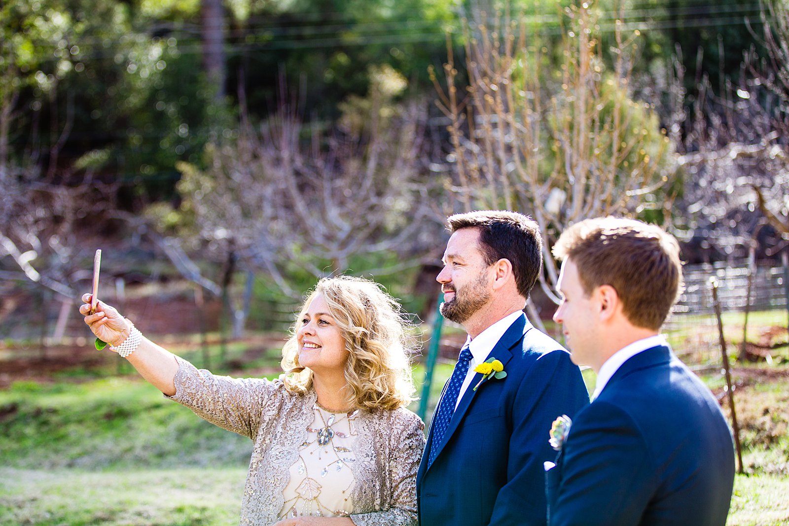Groom and his parents taking a selfie during their Sedona elopement by PMA Photography.