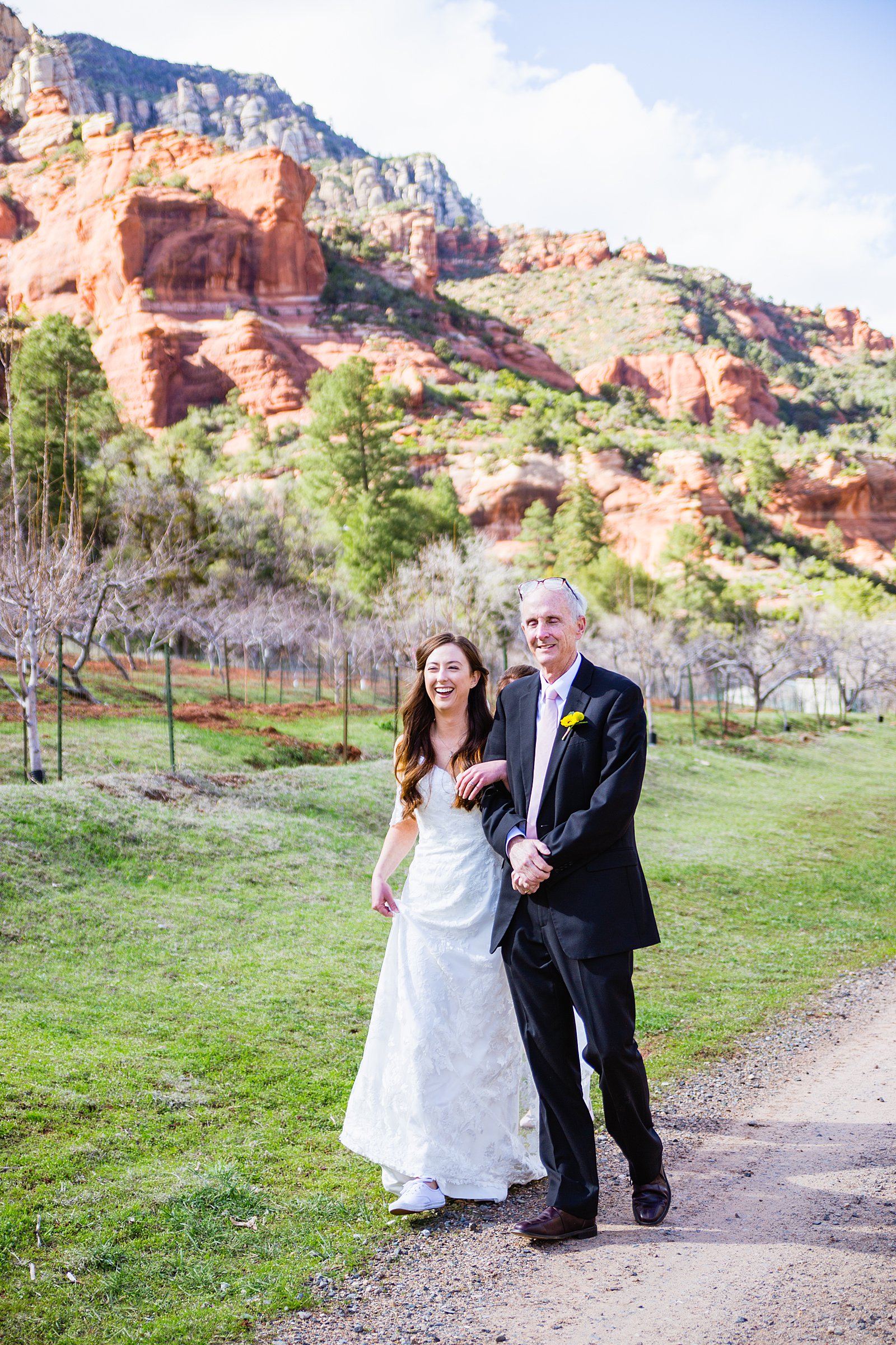 Bride walking down aisle during Slide Rock wedding ceremony by Arizona elopement photographer PMA Photography.