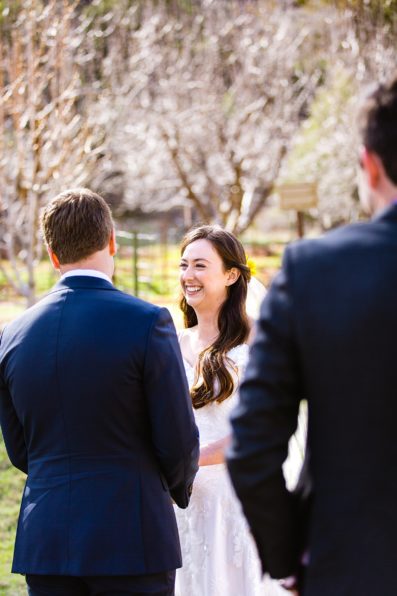 Bride looking at her groom during their wedding ceremony at Slide Rock by Sedona elopement photographer PMA Photography.