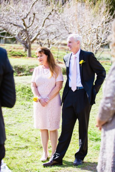 Wedding couple's family during Slide Rock wedding ceremony by Arizona elopement photographer PMA Photography.