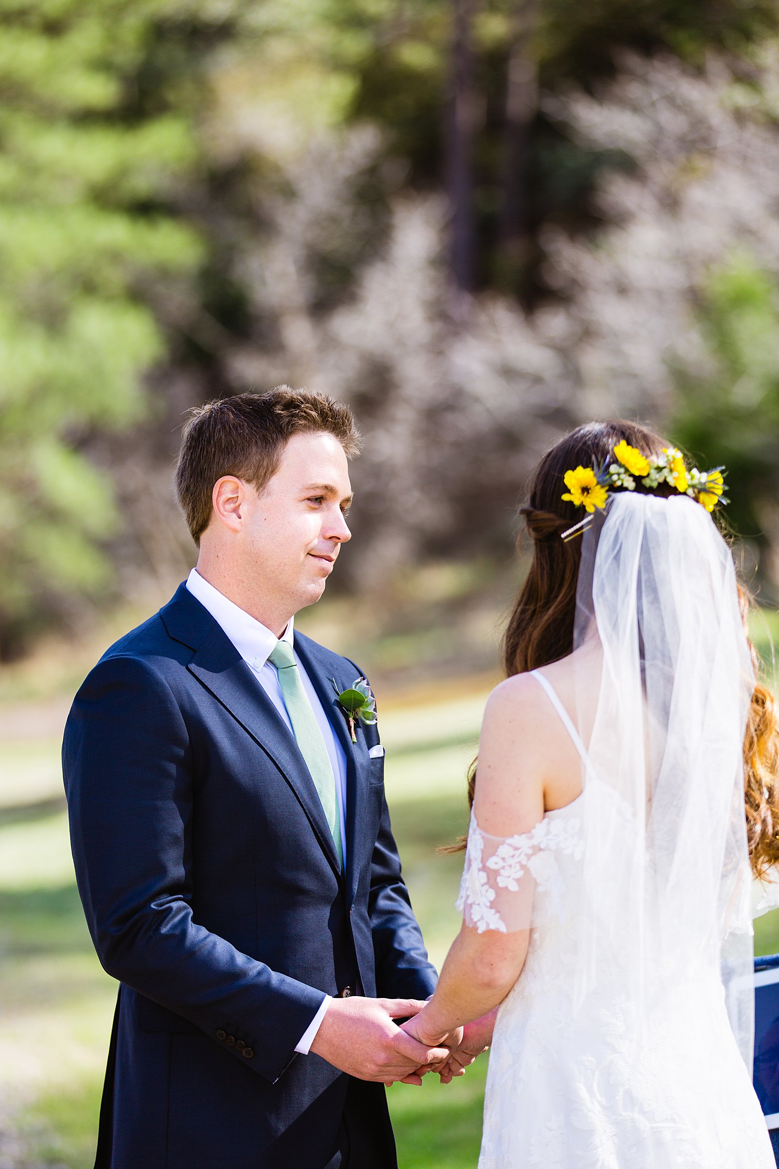 Groom looking at his bride during their wedding ceremony at Slide Rock by Sedona elopement photographer PMA Photography.