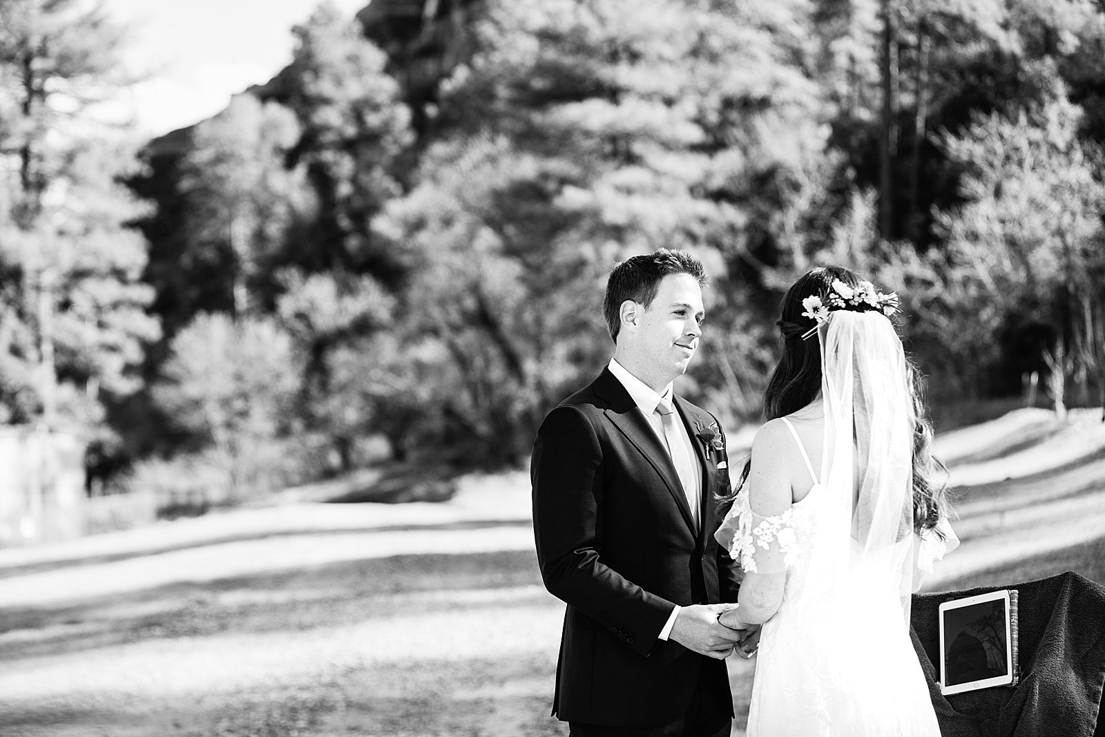 Groom looking at his bride during their wedding ceremony at Slide Rock by Sedona elopement photographer PMA Photography.