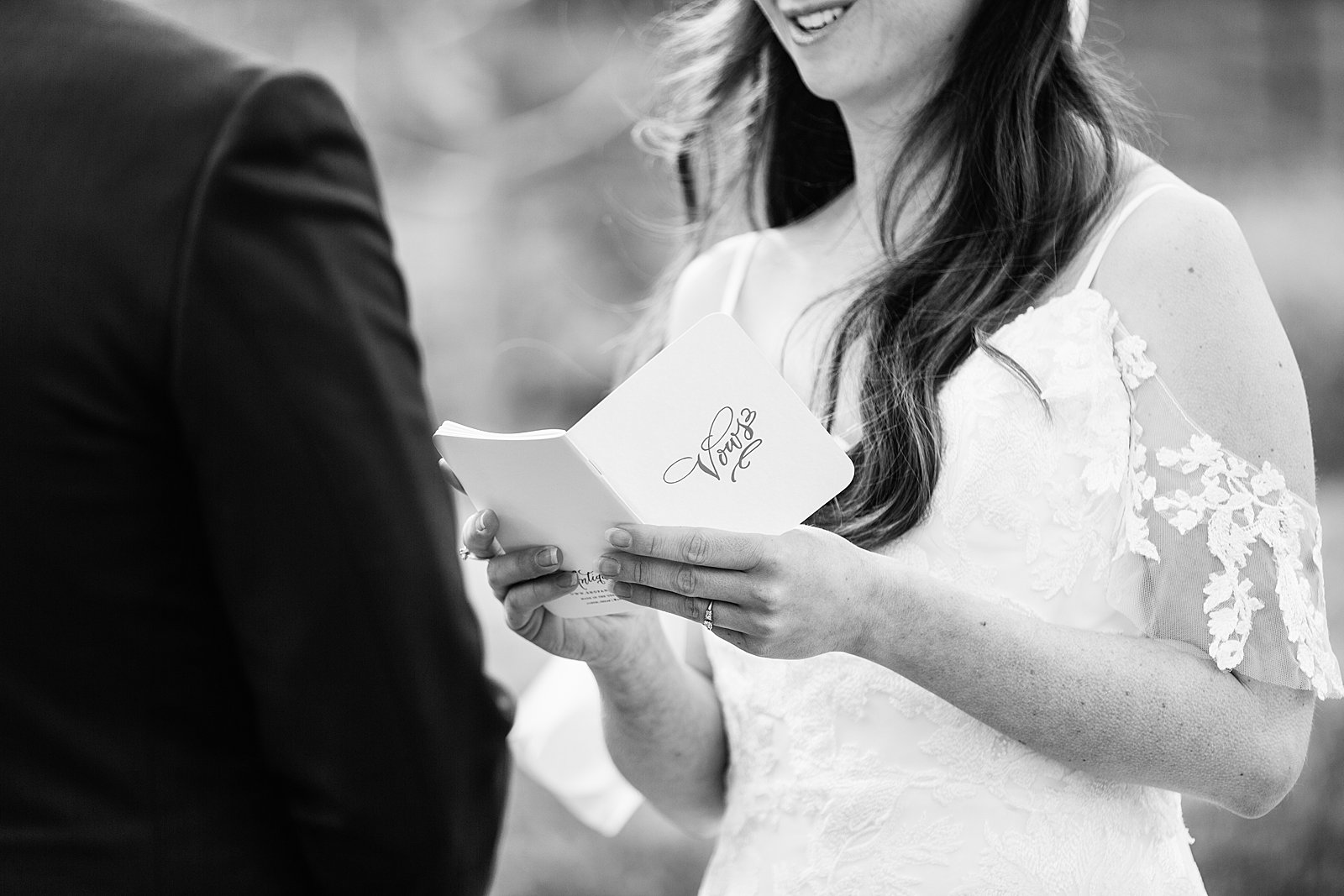 Bride reading her vows from a vow notebook by PMA Photography.