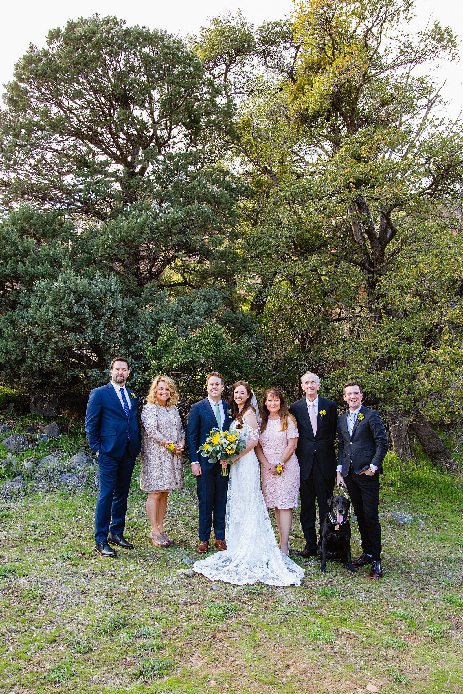 Bride and groom take photos with their family by Sedona elopement photographer PMA Photography.